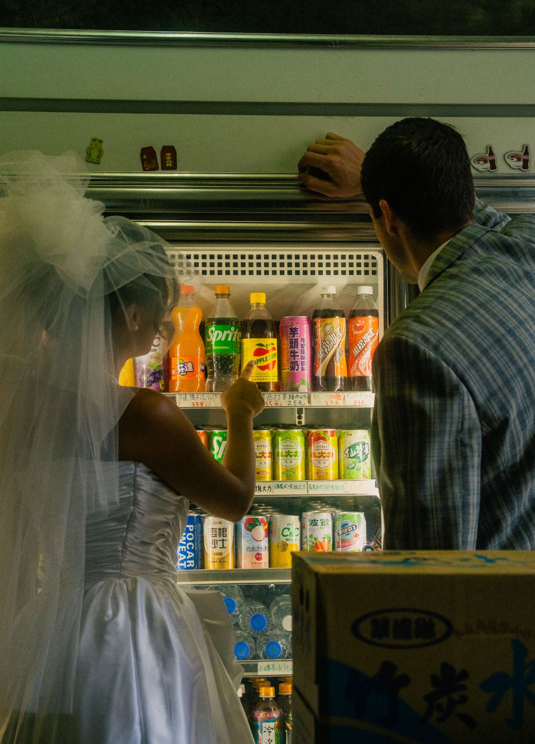 Vintage-inspired Taipei engagement photo of a bride and groom beside a neighborhood convenience shop