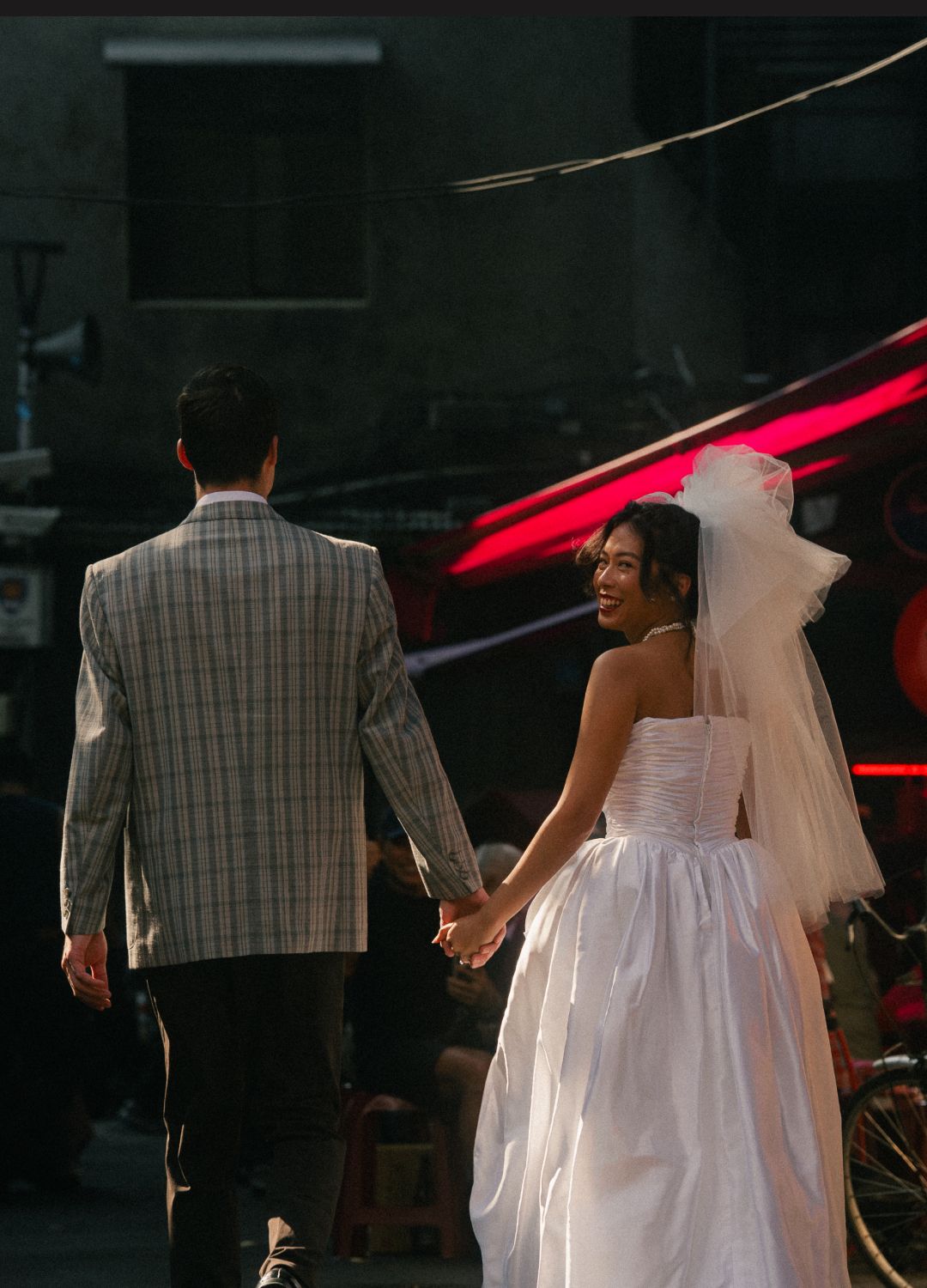 Bride and groom walking through a quiet Dihua Street alley at sunset in Taipei