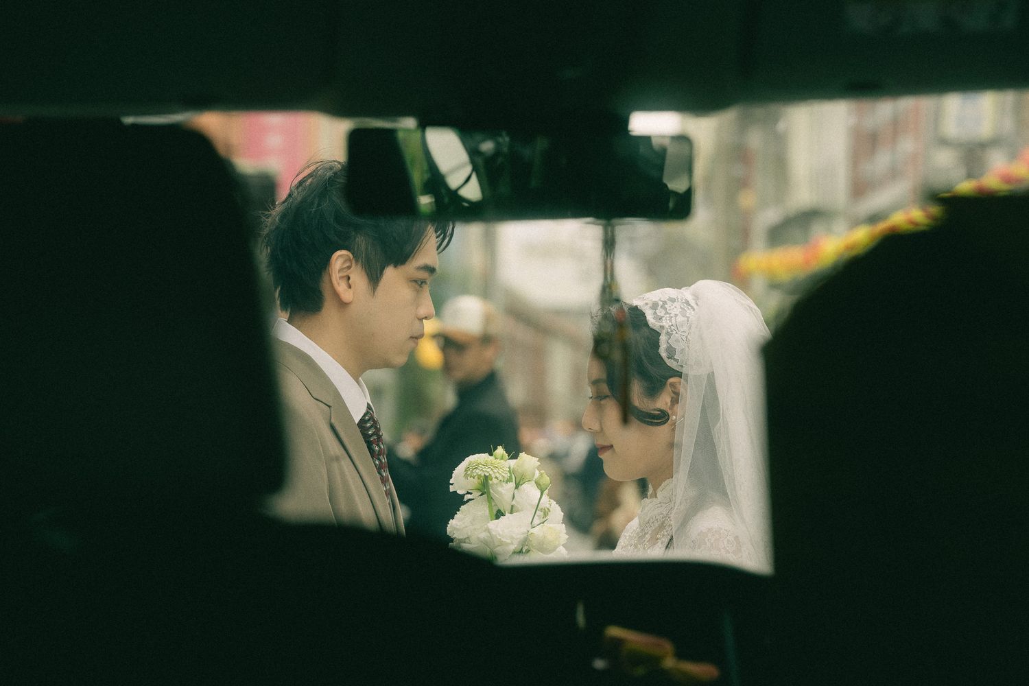 Bride and groom framed through a vehicle window during a cinematic pre-wedding photography session in Taipei