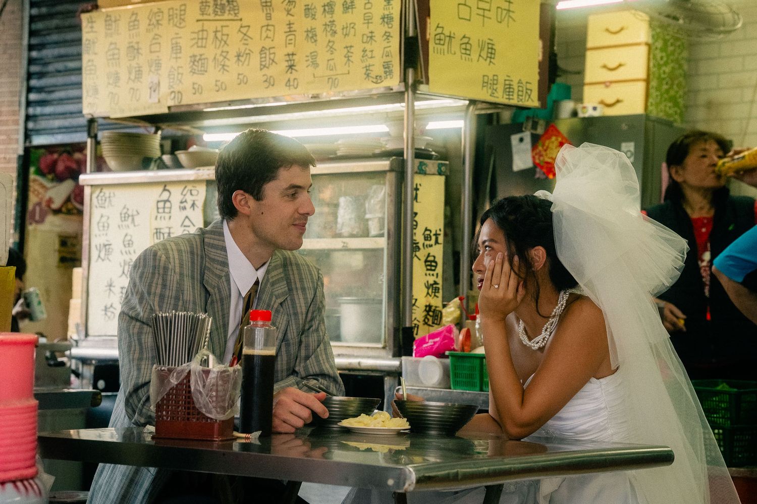 Emily and Rik sharing a quiet moment over noodles at a local Taiwanese food stall in Dadaocheng