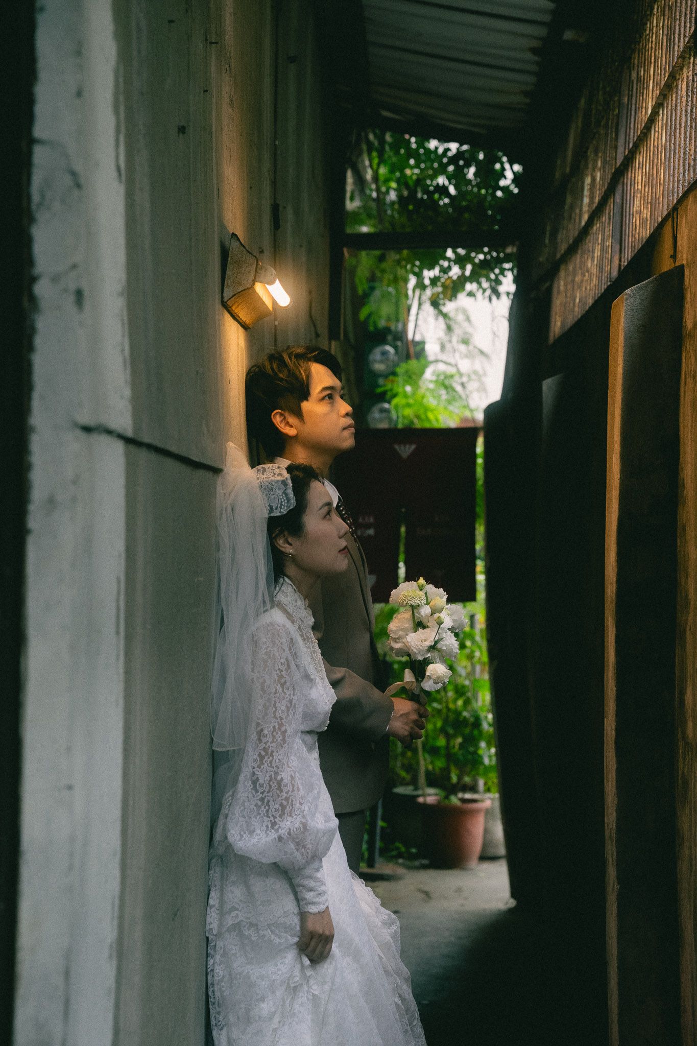 Passing scooter frames a bride and groom during a documentary-style Dihua Street pre-wedding shoot in Taipei