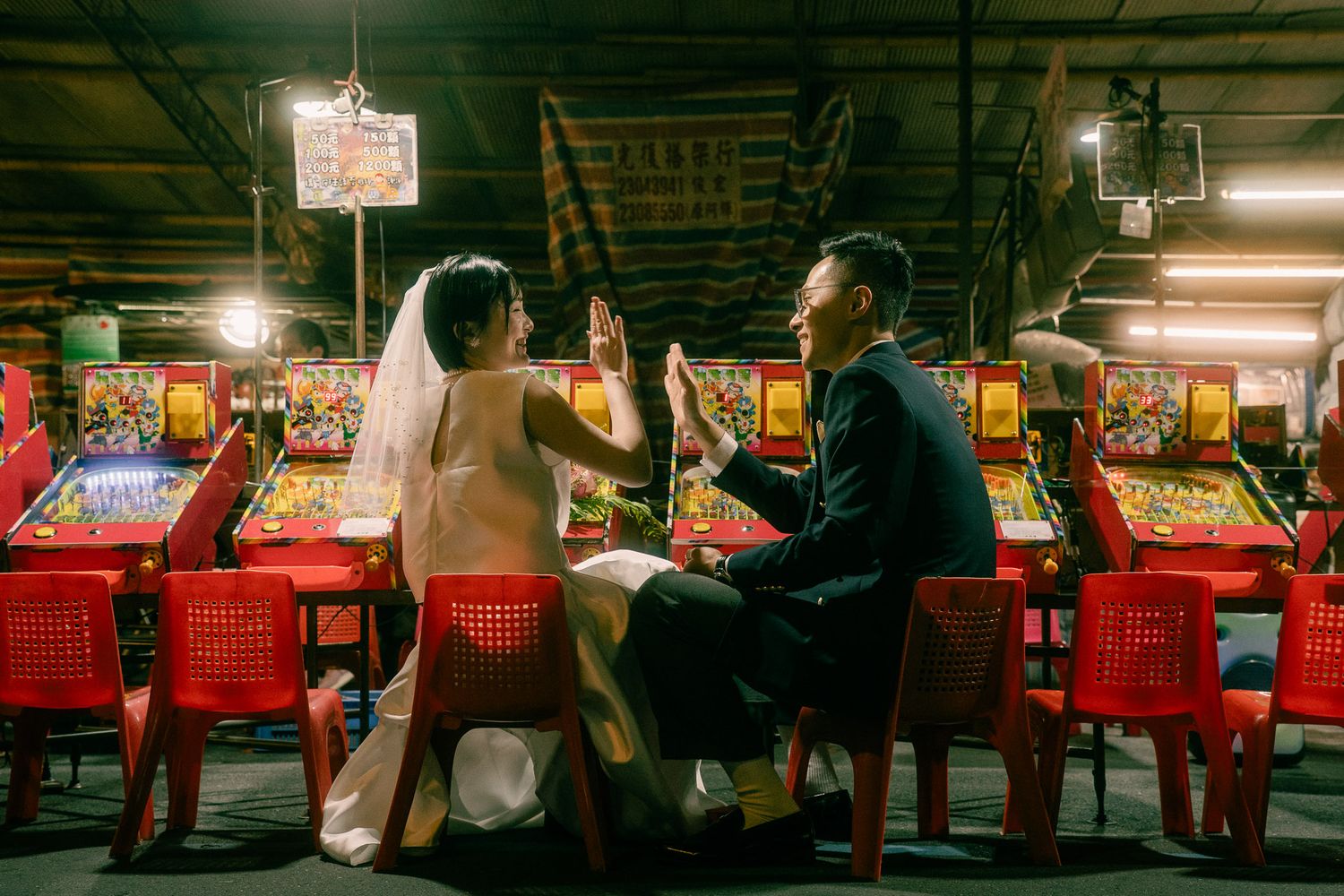 Couple playing pinball during a cinematic Taipei pre wedding photography session