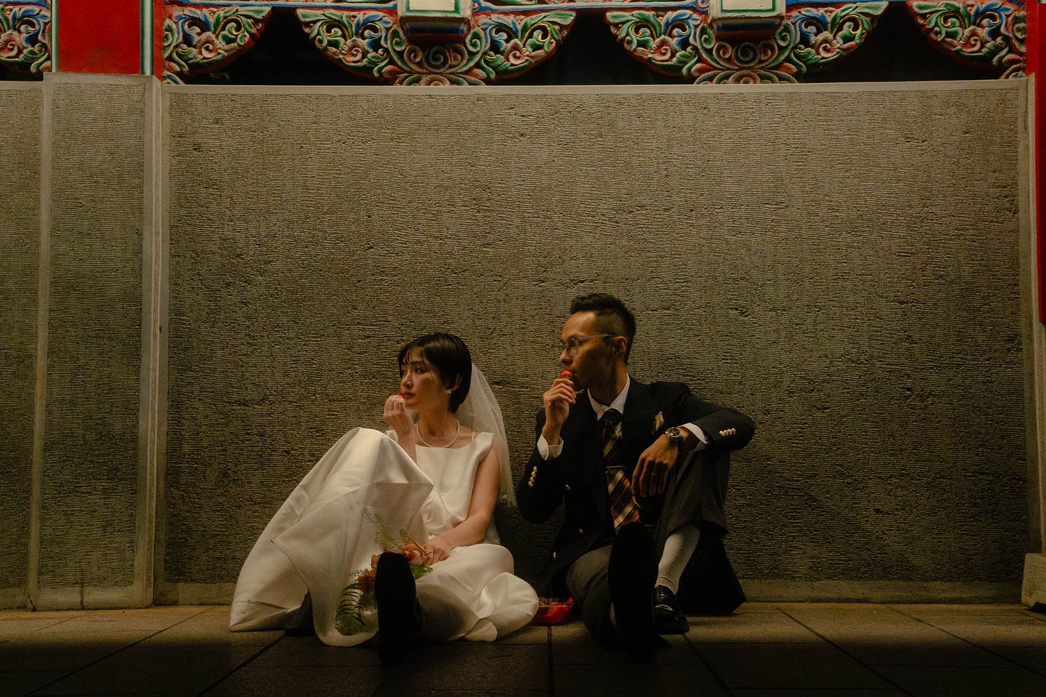 Sunny and Leo laughing while sharing strawberries during their documentary-style Taipei pre-wedding photography session