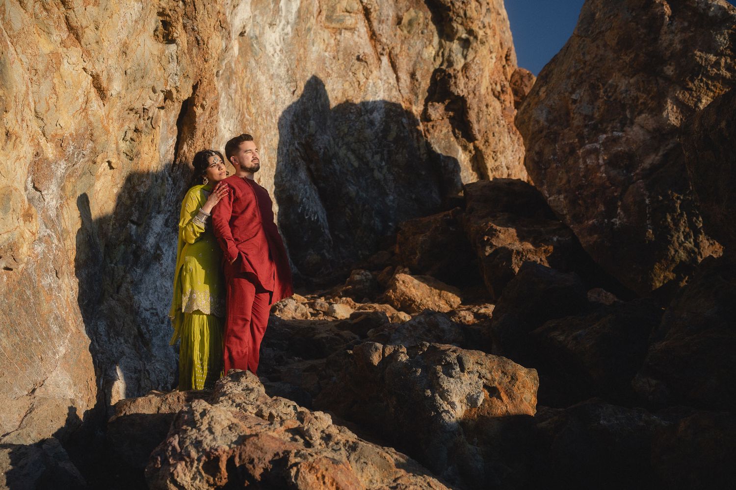 Cinematic Taiwan couple portrait on a rocky landscape at golden hour