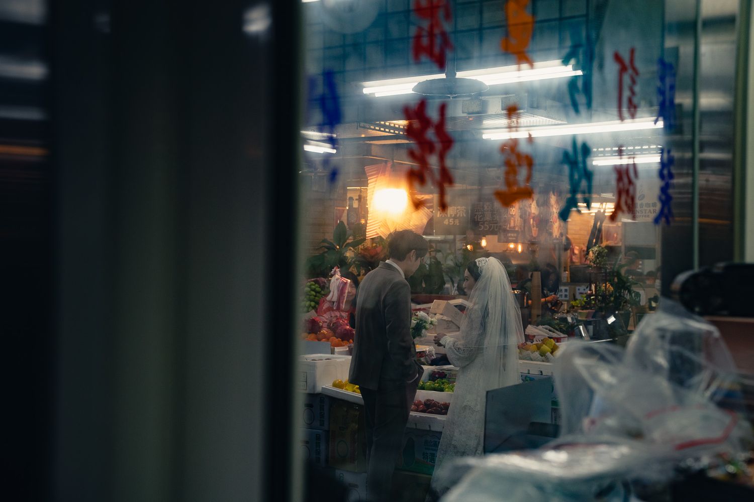 Cinematic Taipei pre-wedding photography of a couple inside a traditional Taiwanese market