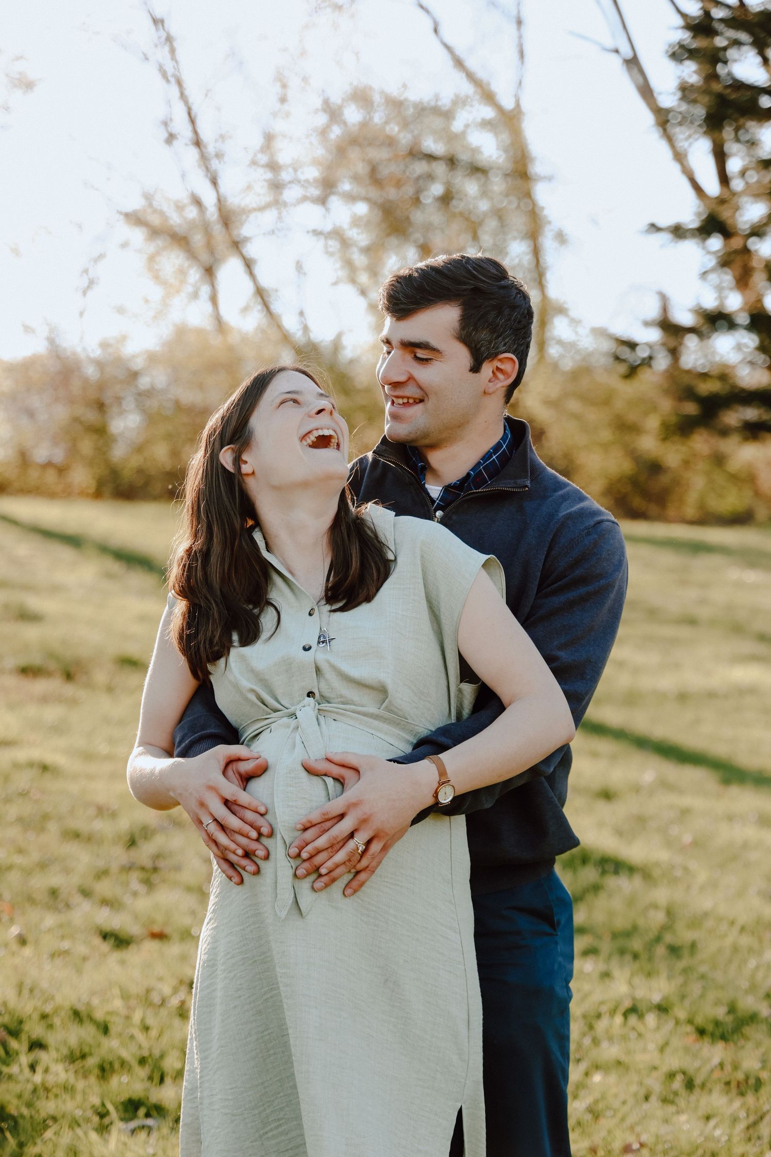 Catholic couple embracing during their maternity session, joyfully awaiting their baby boy with tender pro‑life and first‑time‑parent love