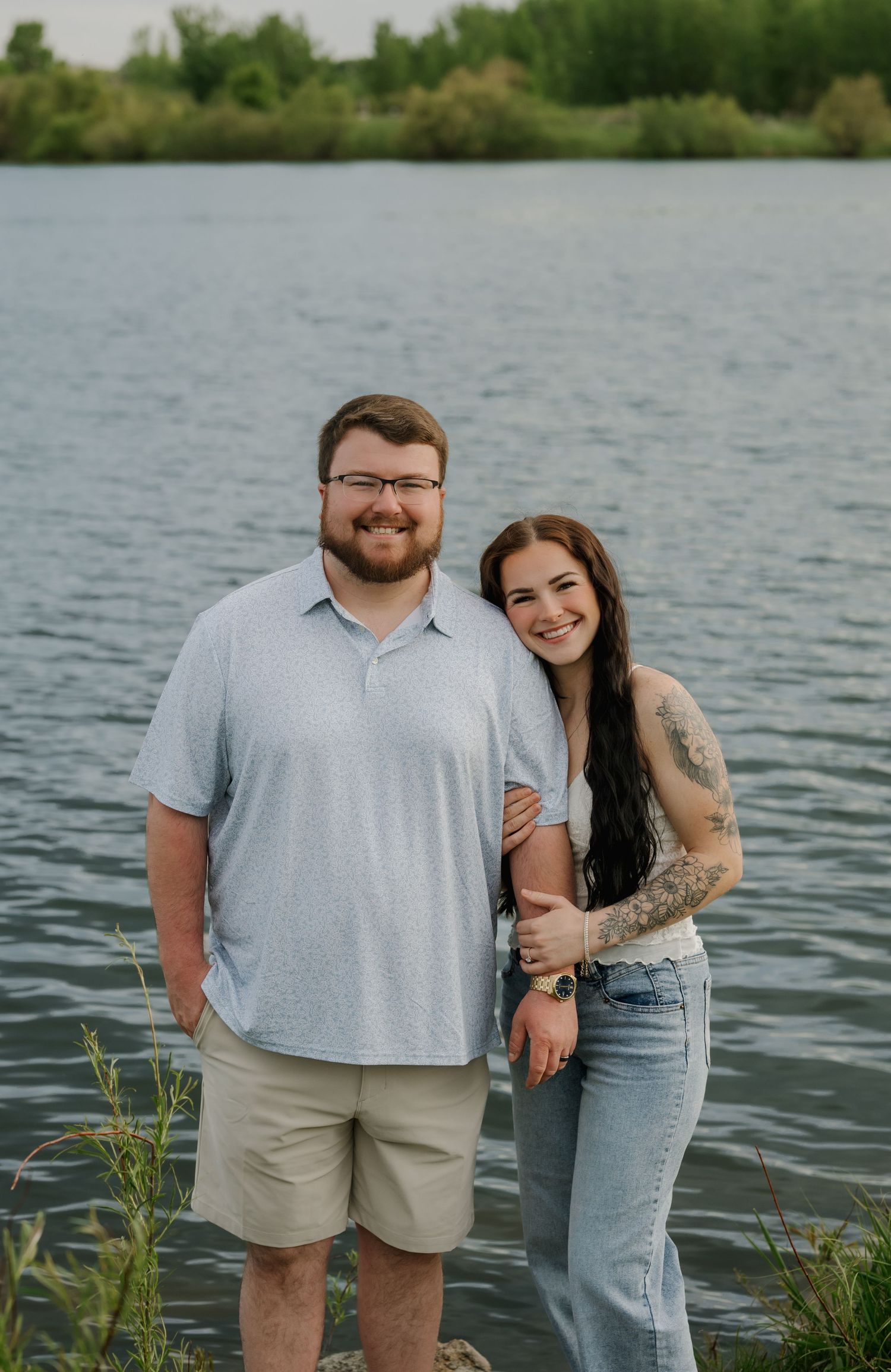 Romantic couple laughing together in an open field during sunset photos in Des Moines Iowa