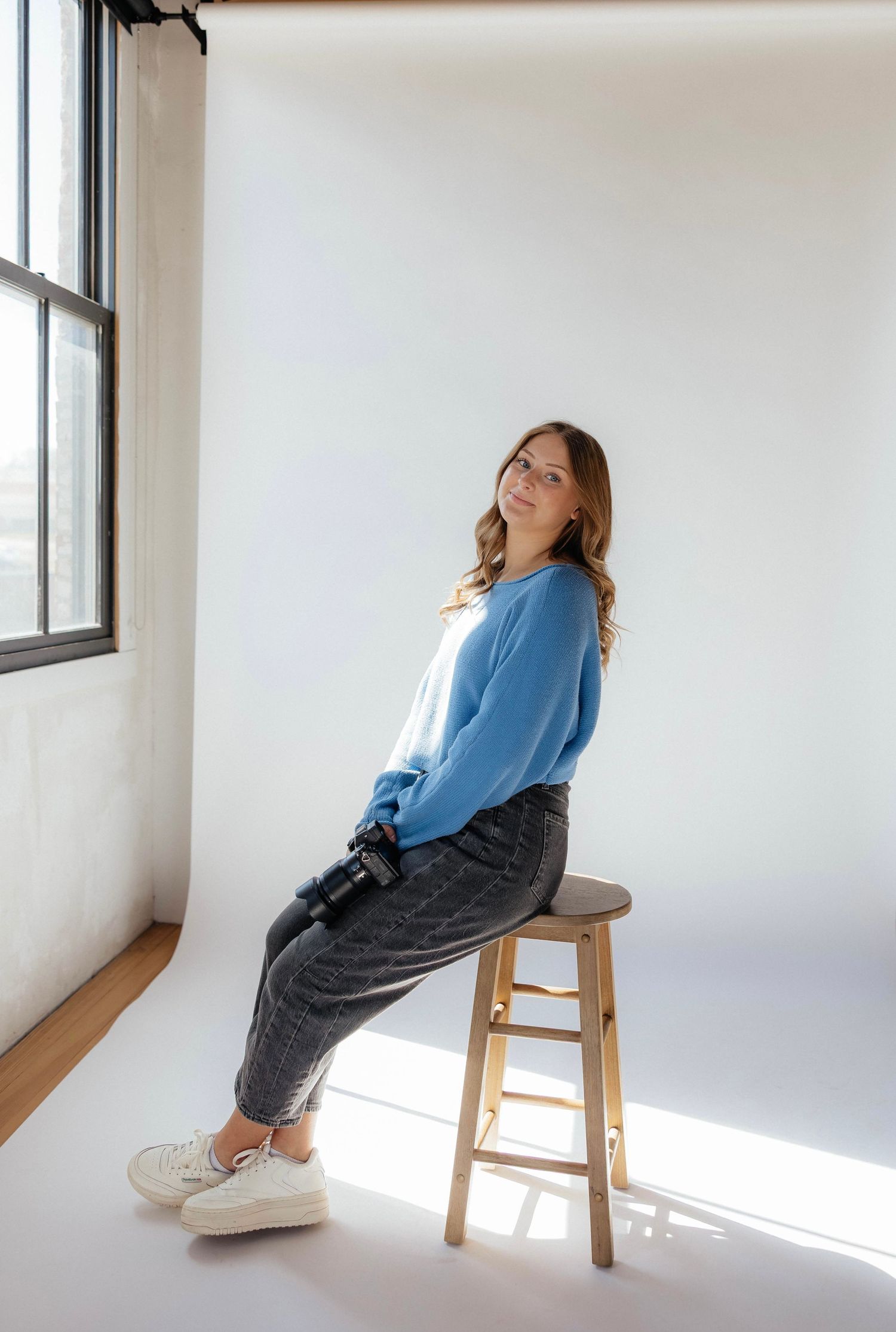 Creative business owner working in studio space during branding photography session in Iowa