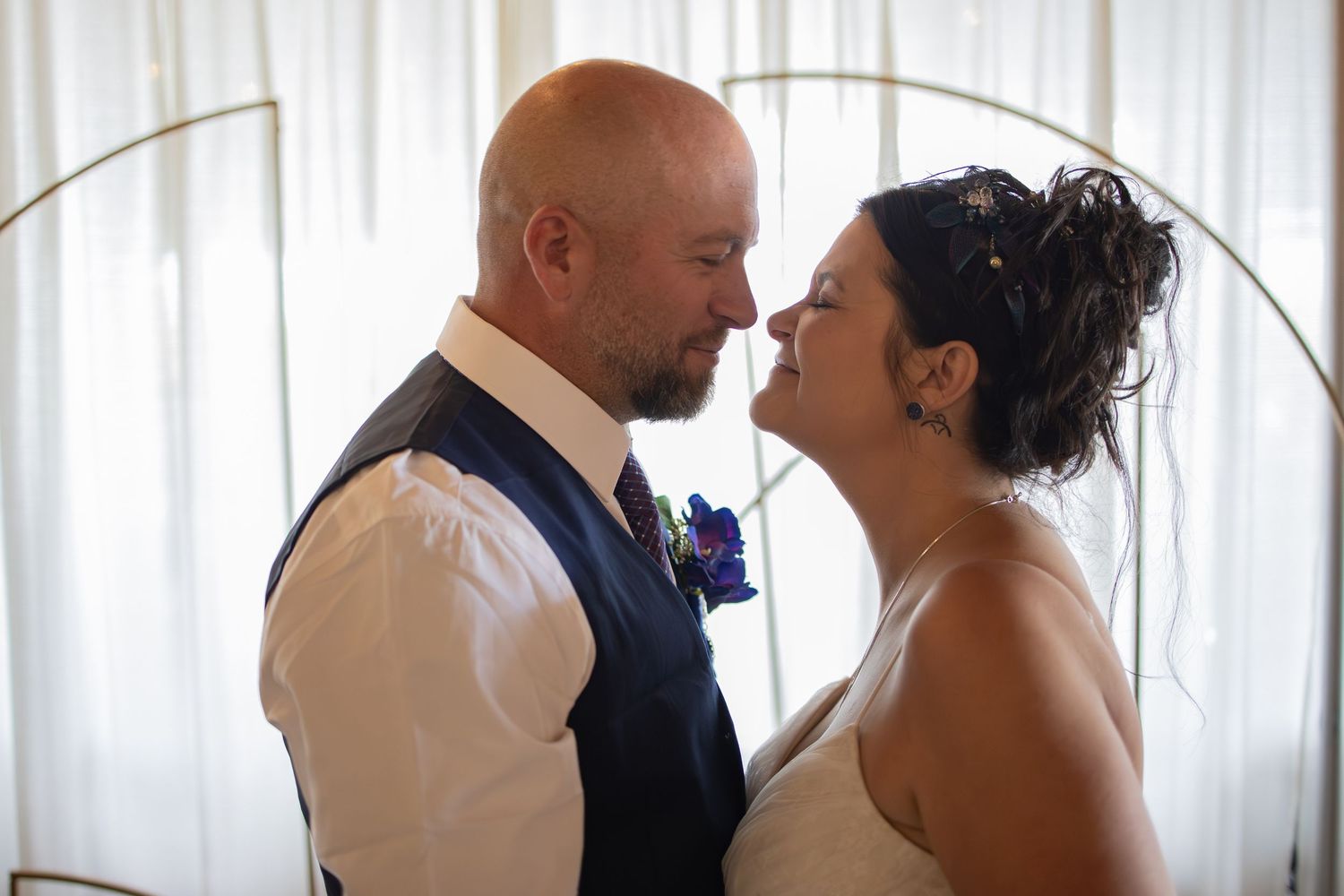Wedding celebration with formal attire in an elegant indoor setting.