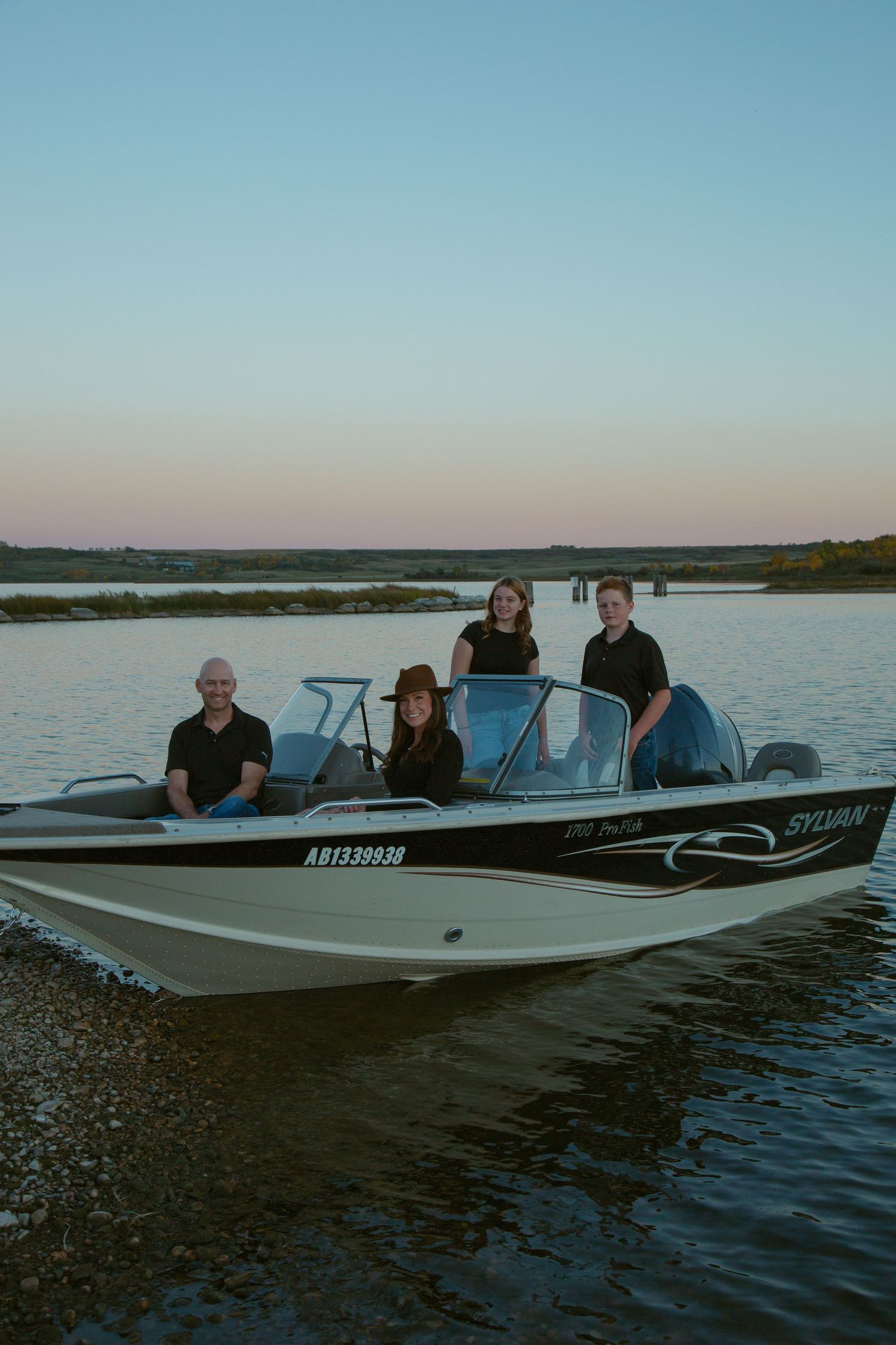Several motorboats floating on calm waters during a peaceful evening.