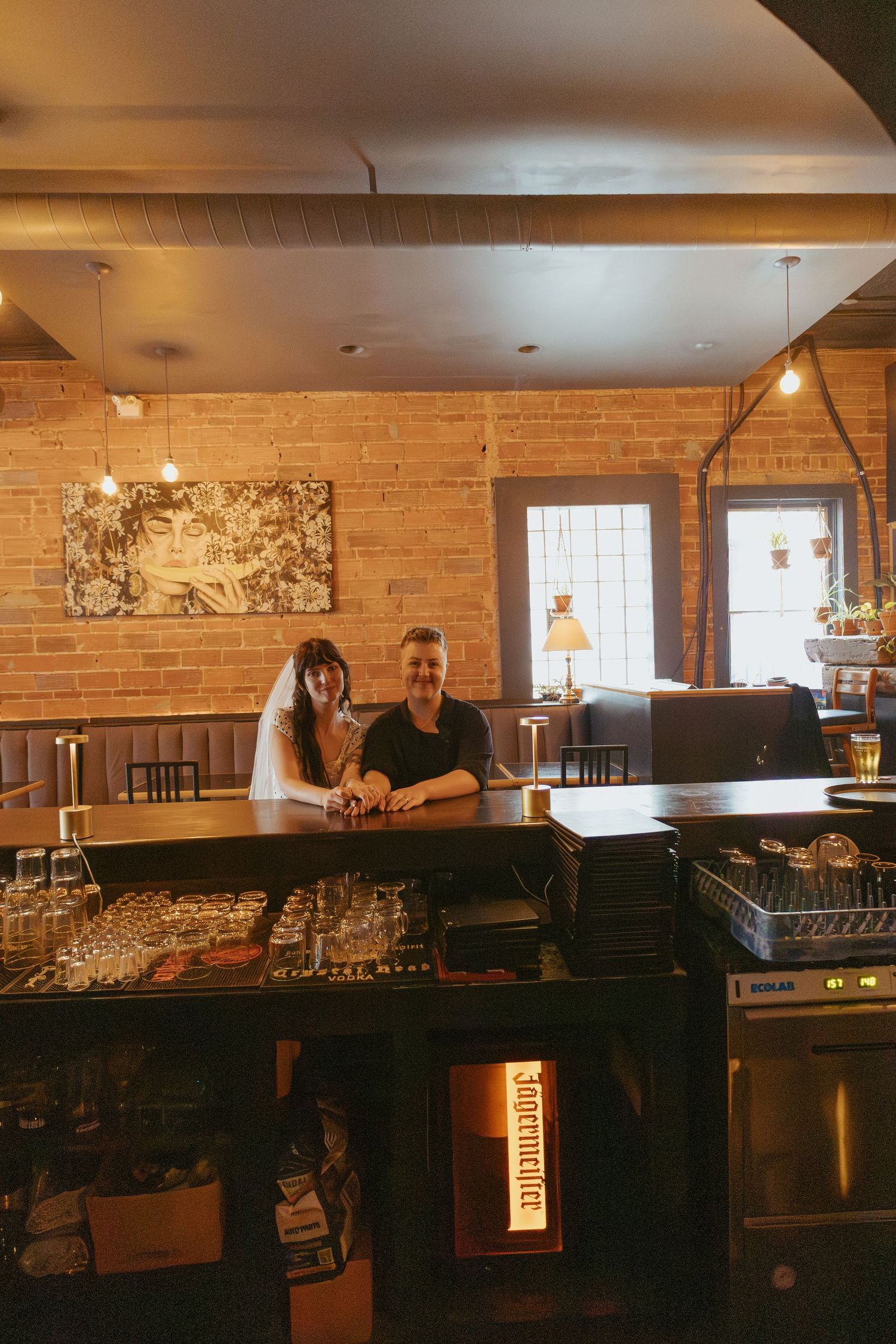 Rustic bar space with exposed brick walls and pendant lighting creating warm ambiance.