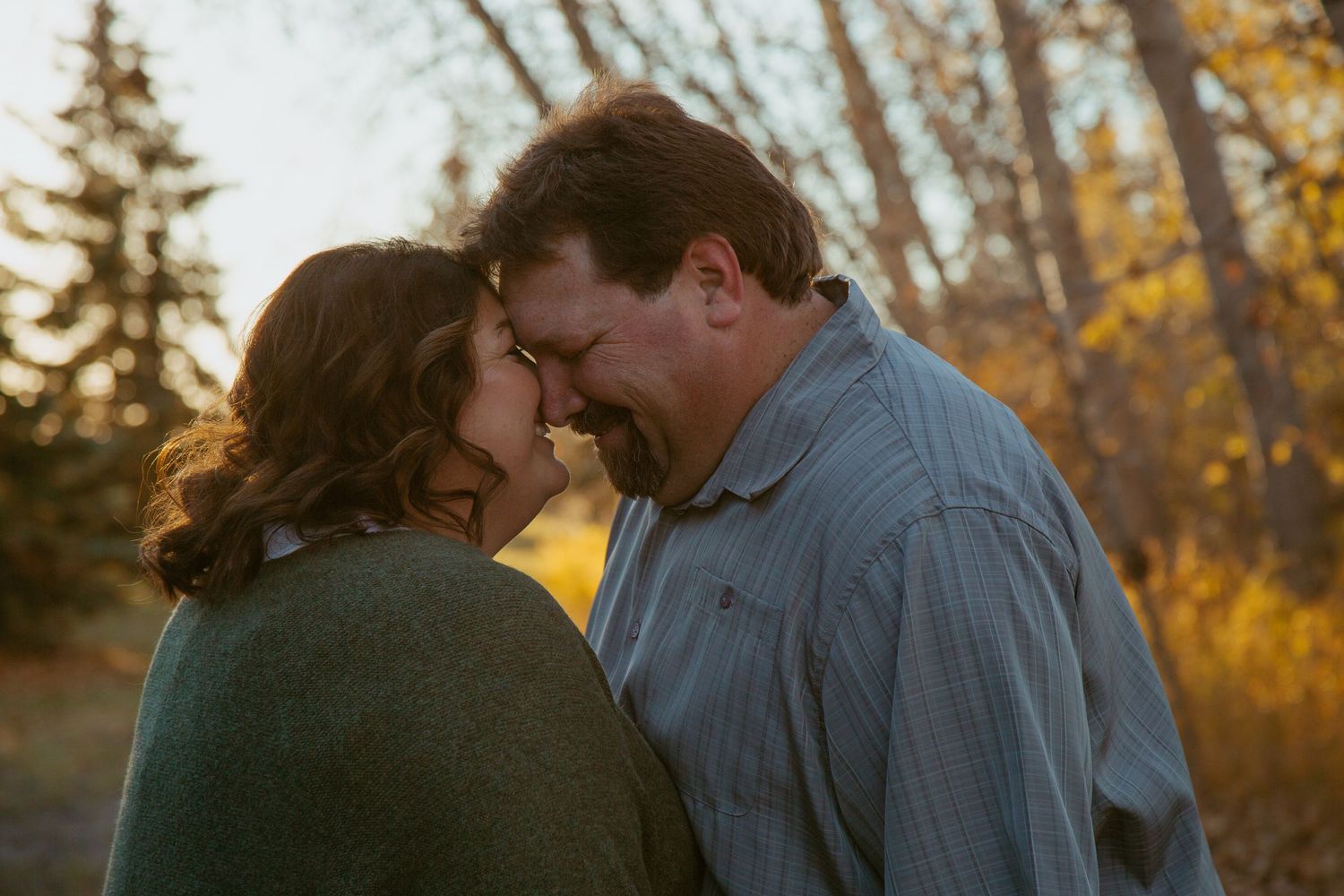 Intimate moment shared between two people during golden hour in autumn.