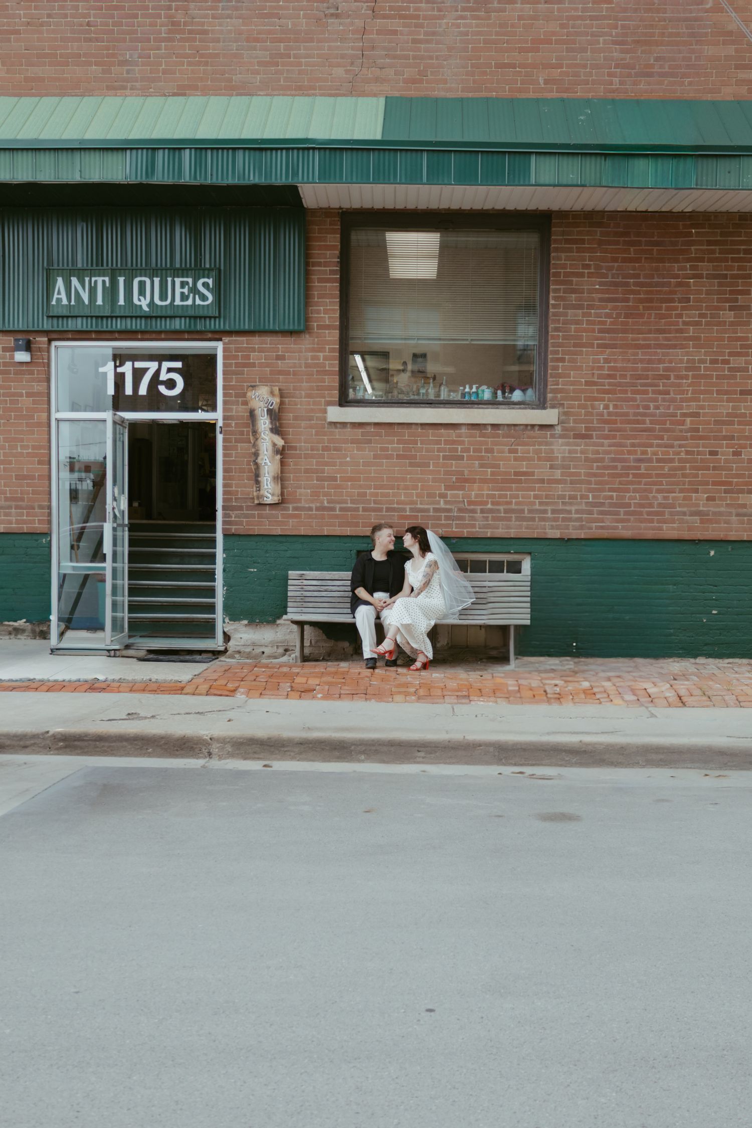 Exterior view of a brick building with an antiques store sign.
