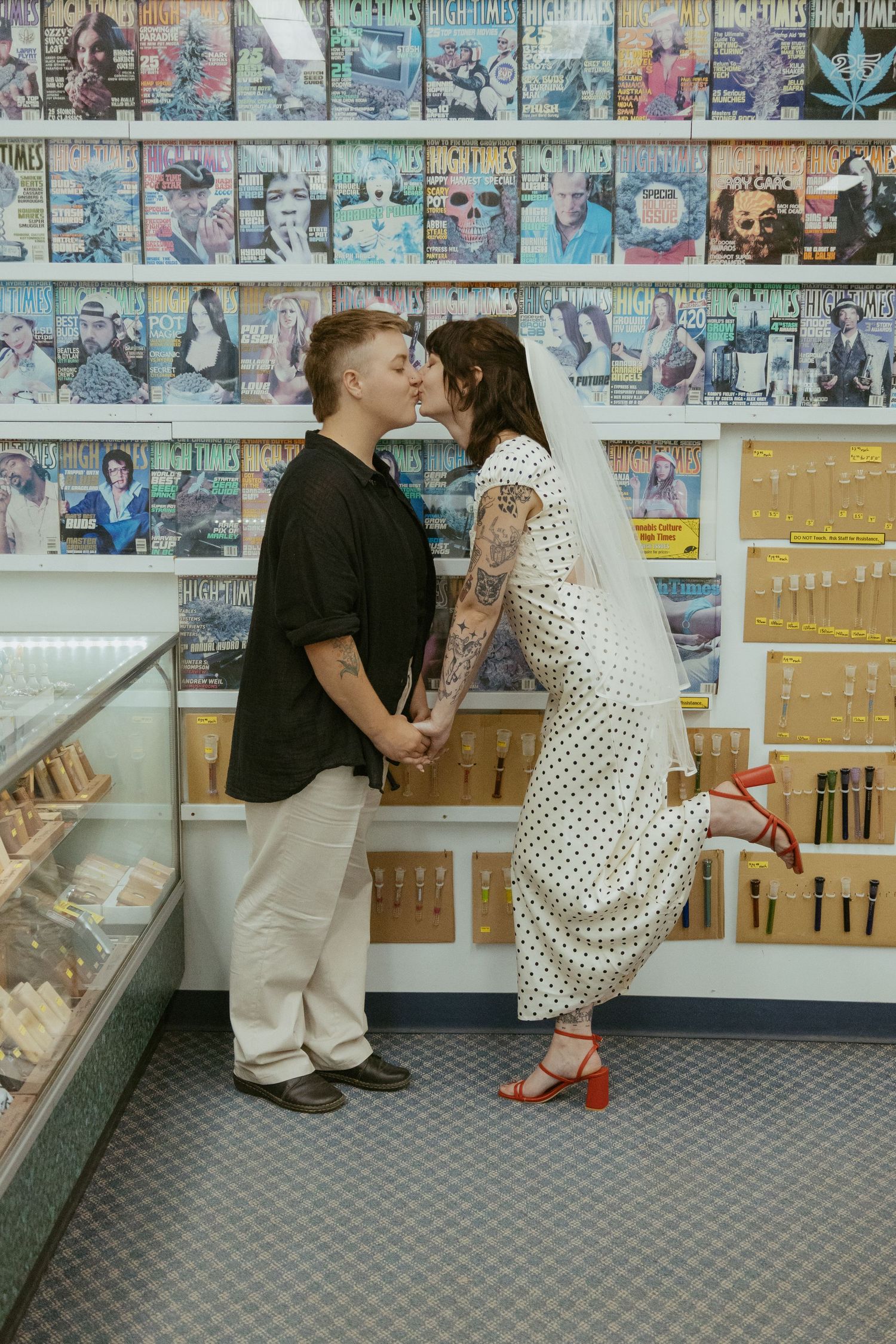 Two people sitting on the floor of a music store surrounded by CD racks.