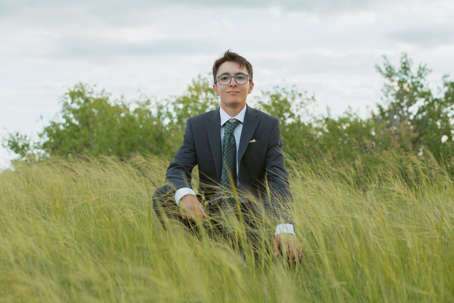 A scenic outdoor portrait session in tall grass fields.