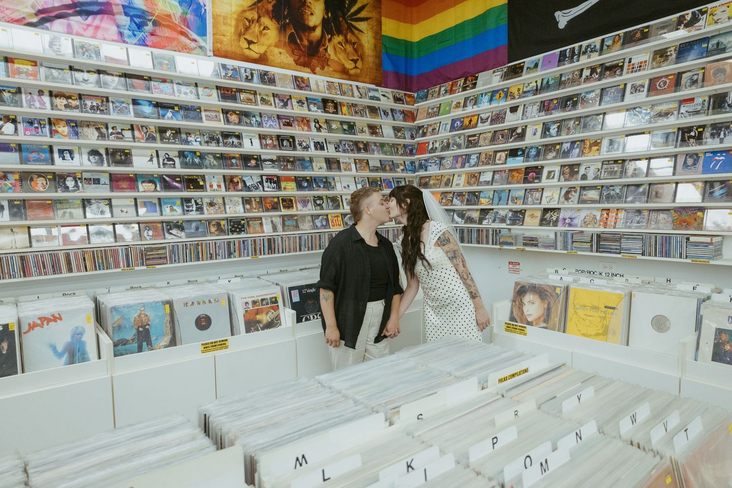 Record store with colorful wall displays showcasing extensive vinyl collection.