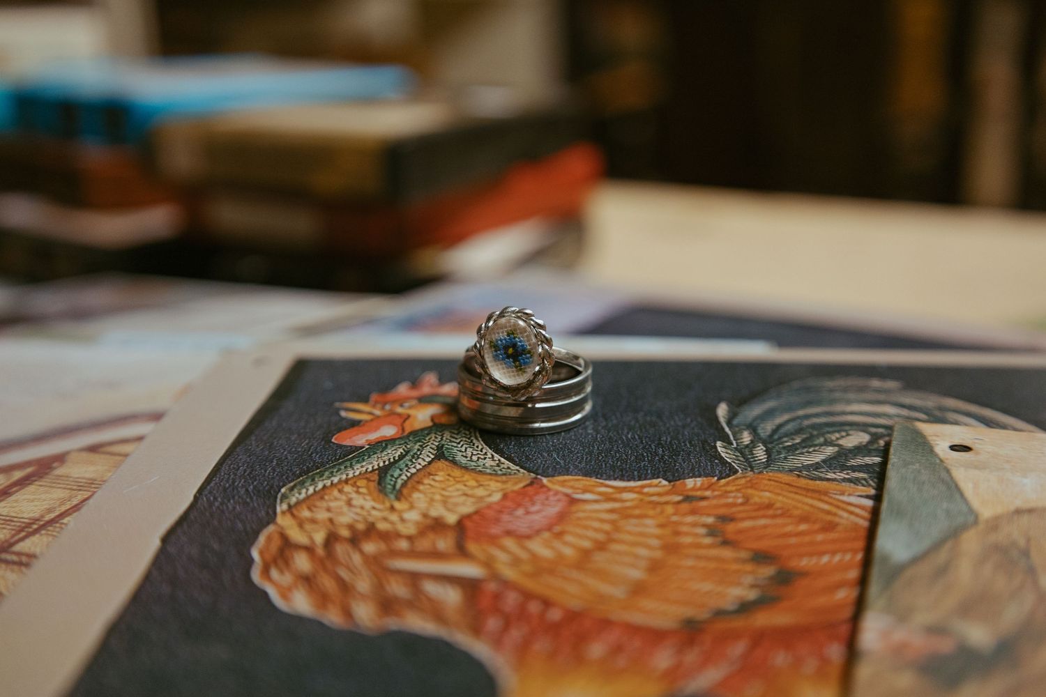Close-up shot of wedding rings on a decorative surface with artistic details.