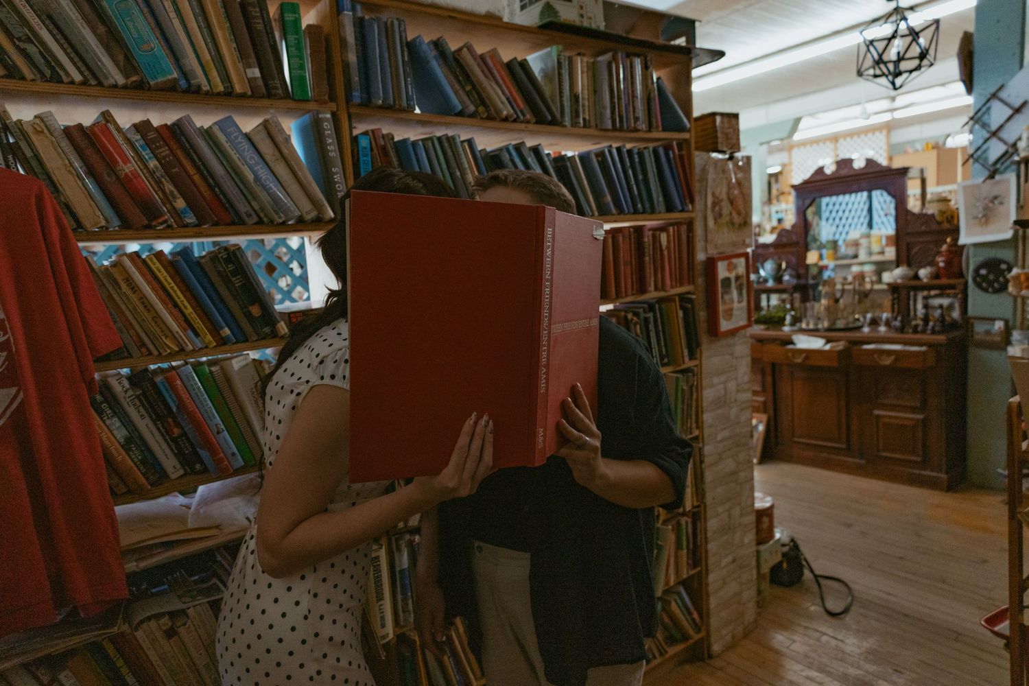 A vintage library interior with wooden shelves filled with old books.