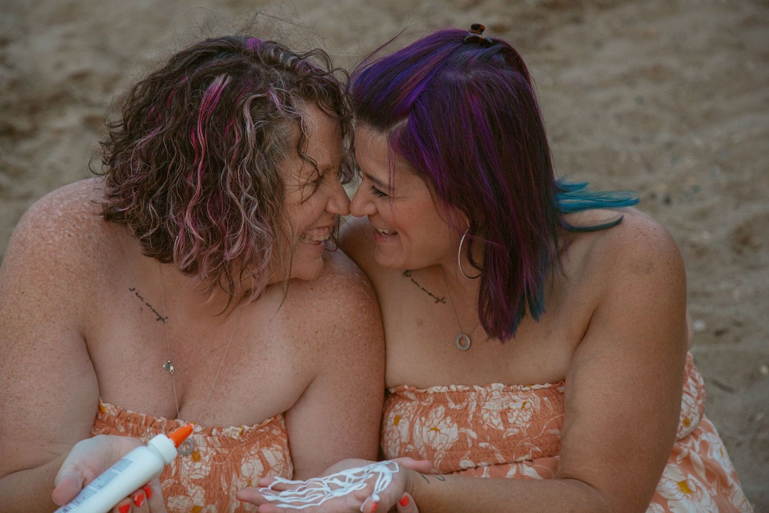 Intimate beach portrait session at sunset with soft lighting.