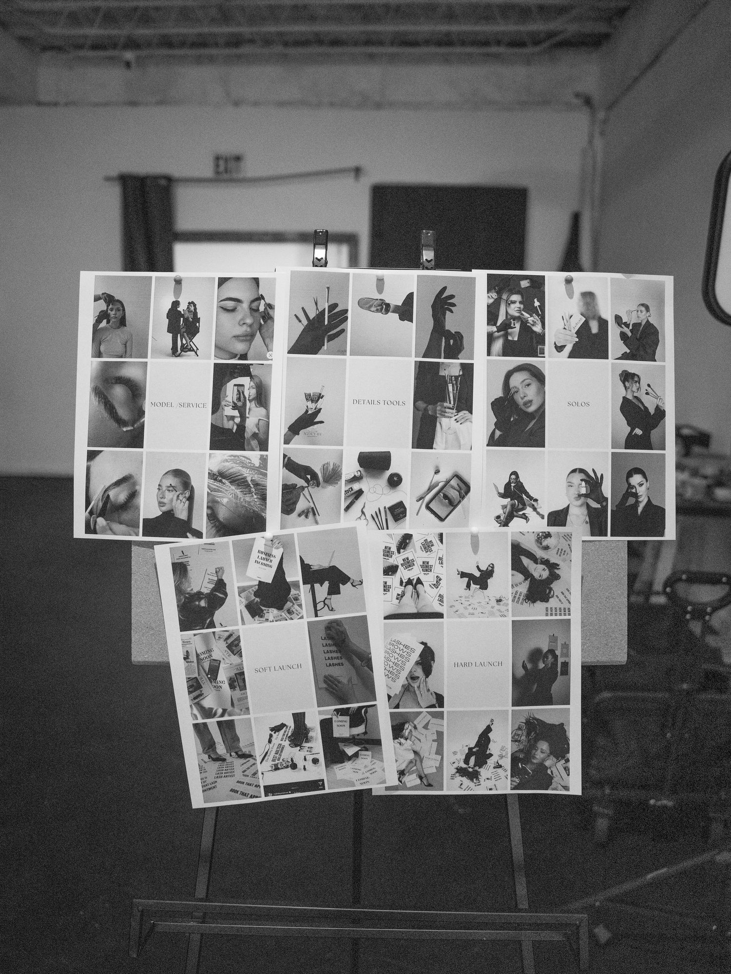 Black and white photo collage displayed on an easel, featuring multiple artistic portrait and detail shots arranged in a grid.