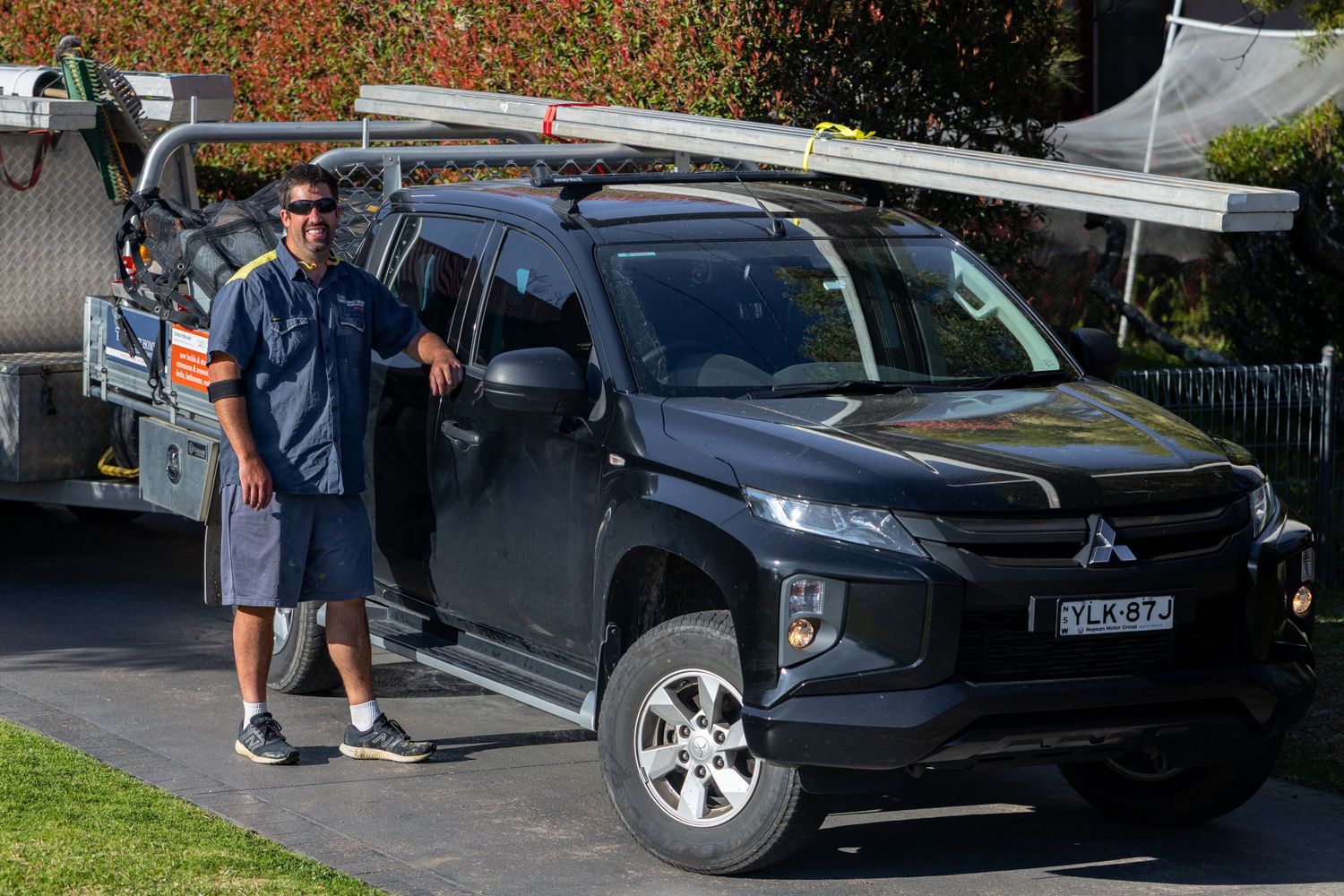 Black SUV with open hood parked on residential street in Springwood, Blue Mountains.