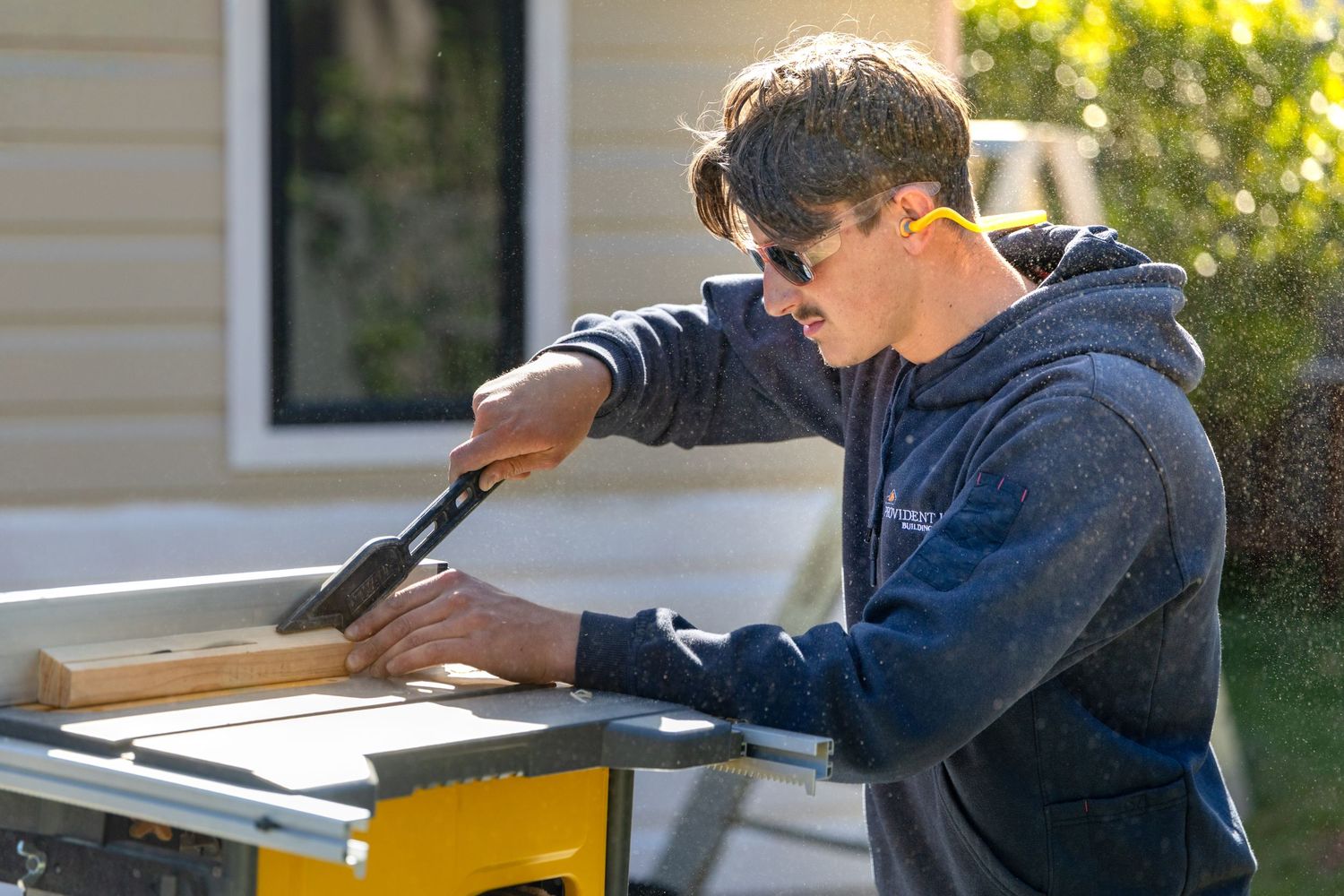 Worker installing or repairing wooden boards on an exterior surface in Springwood, Blue Mountains.