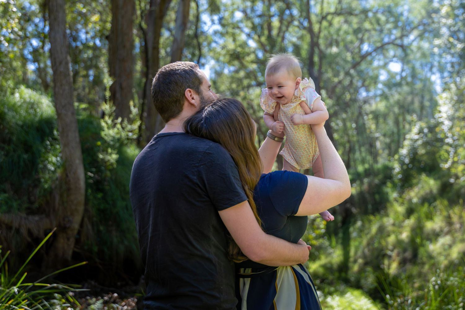 A couple shares a tender moment with their baby at Euroka Clearing in Glenbrook, Blue Mountains.