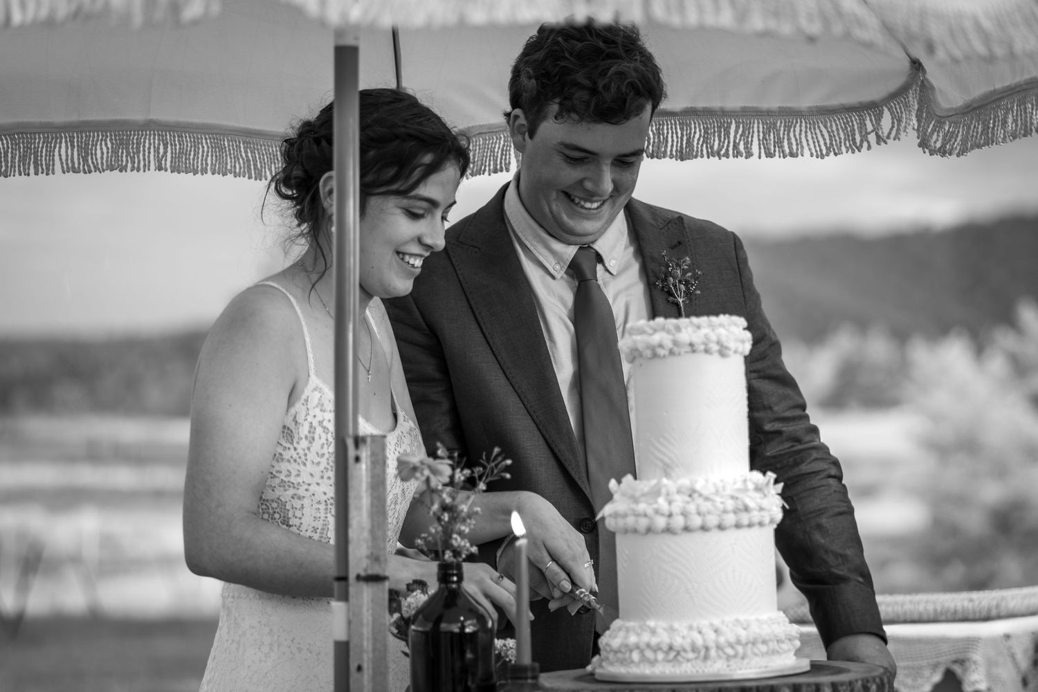 Black and white wedding photo series showing moments of cake cutting at a reception in Singleton, Hunter Valley.