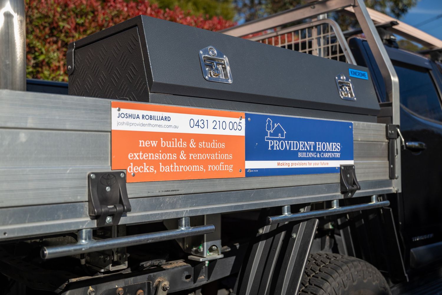 Commercial service truck with company branding and signage parked in parking lot in Springwood, Blue Mountains.