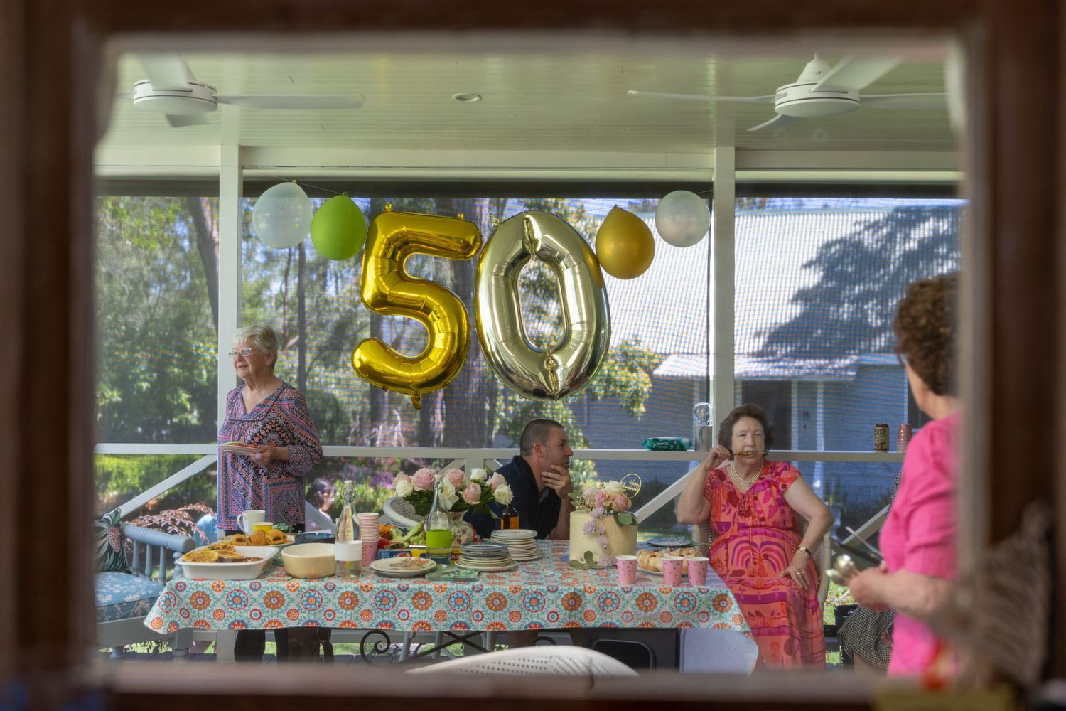 Party decorations including gold number balloons visible through the kitchen window in Glenbrook, Blue Mountains.