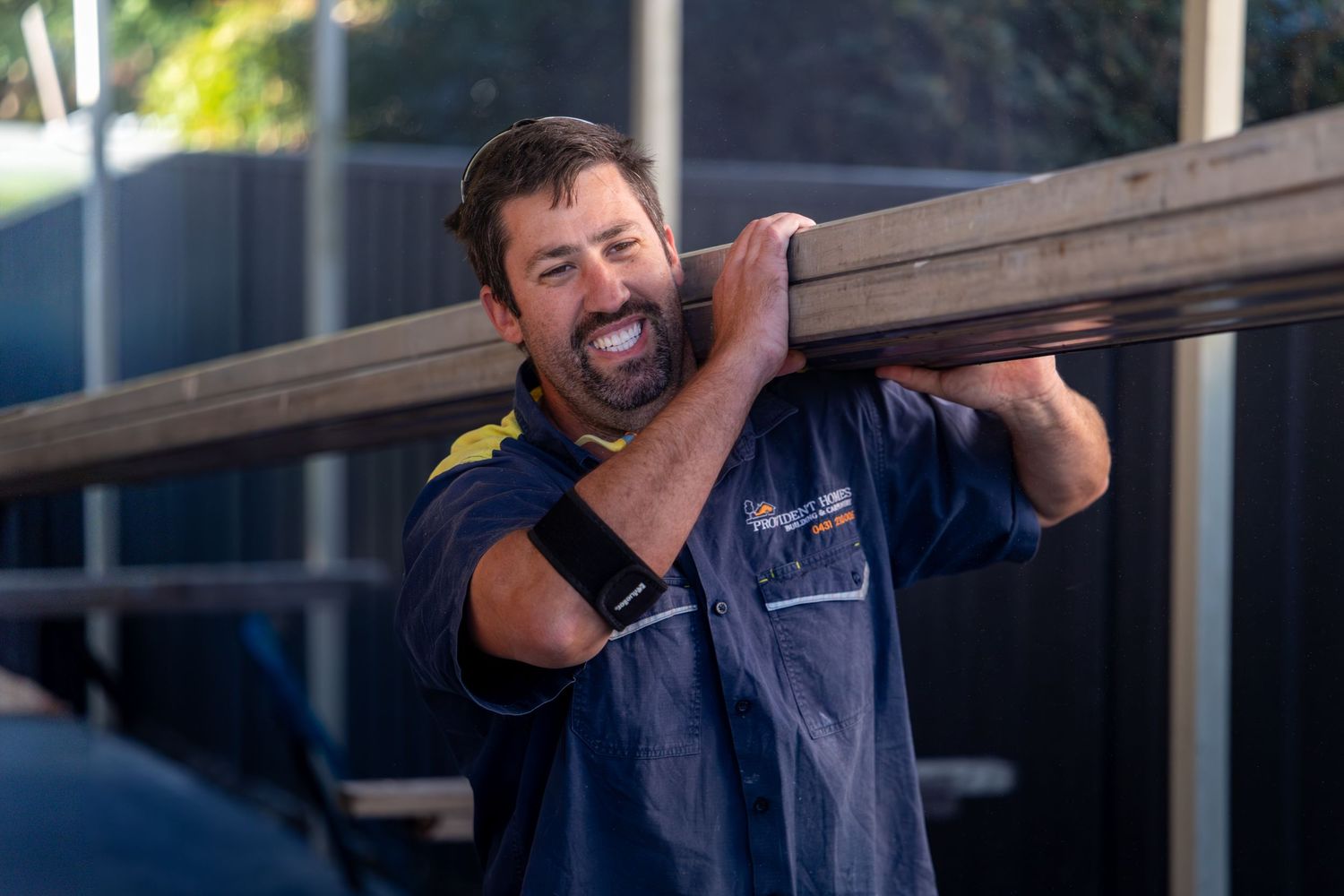 Service worker in blue uniform performing maintenance work outdoors in Springwood, Blue Mountains.