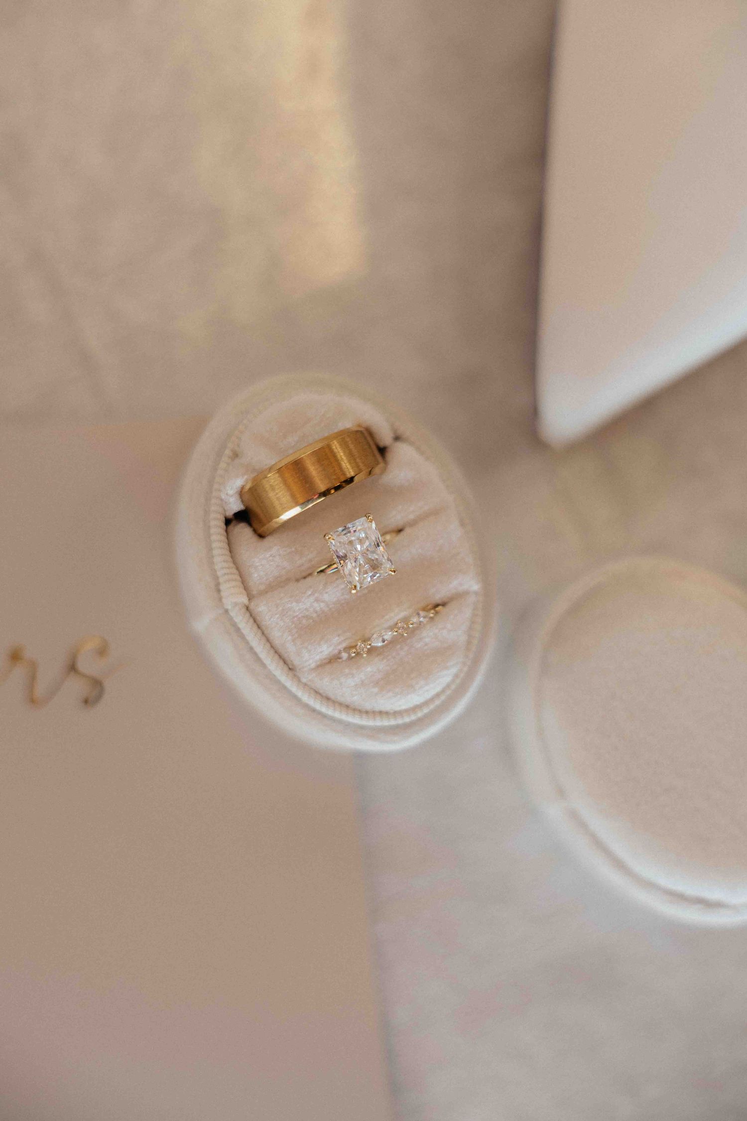 Wedding flat lay with invitation suite and rings