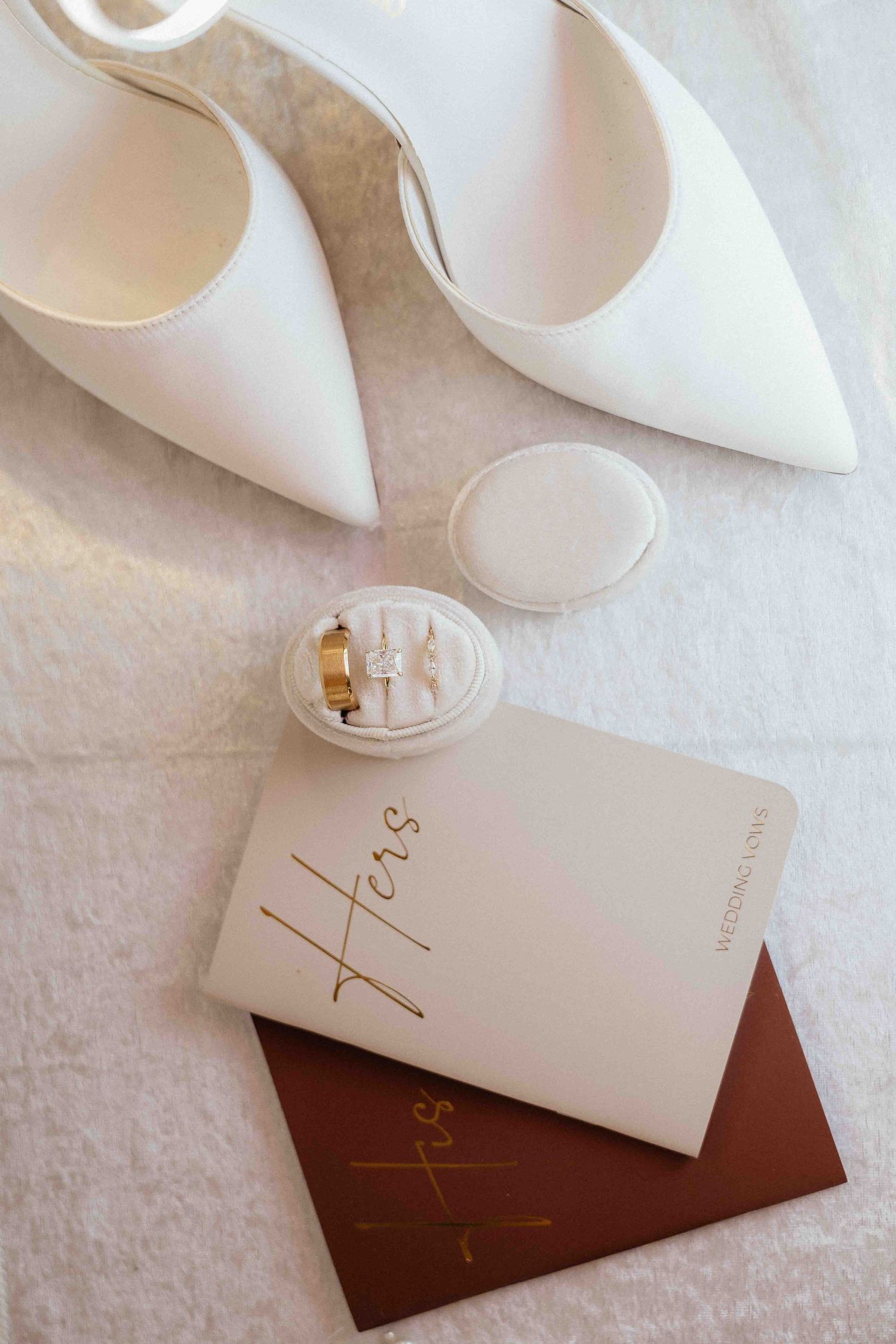 Wedding flat lay with invitation suite and rings