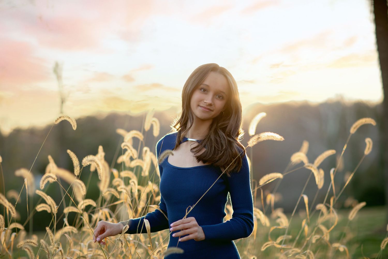 Golden hour portrait in a field of tall wheat grass.