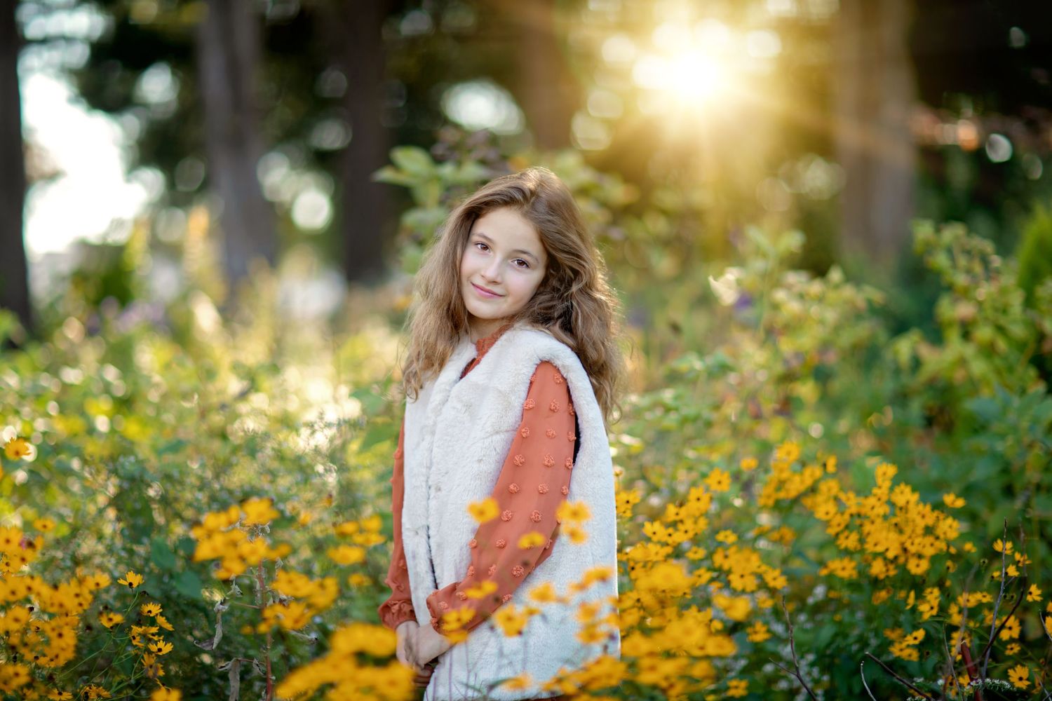Portrait session in a vibrant field of yellow wildflowers during golden hour sunset.