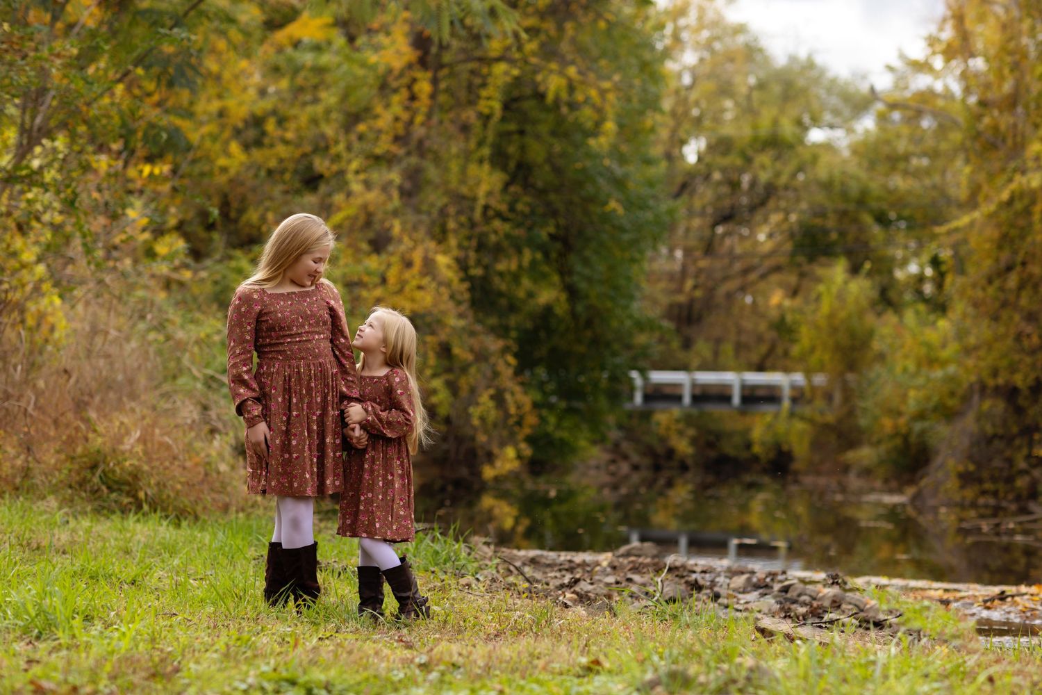 Family exploring nature together on an autumn trail.
