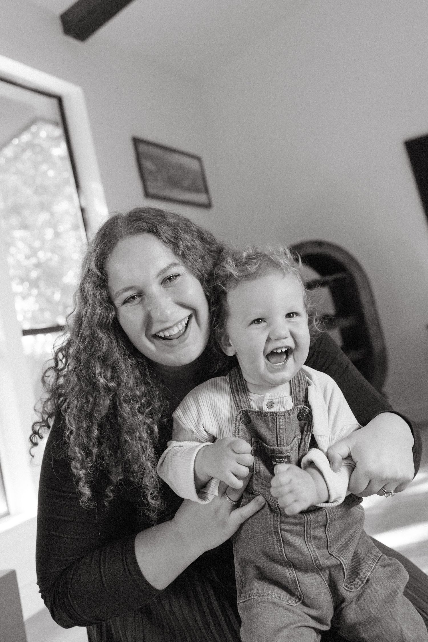 Joyful candid moments shared between parent and child with natural laughter.