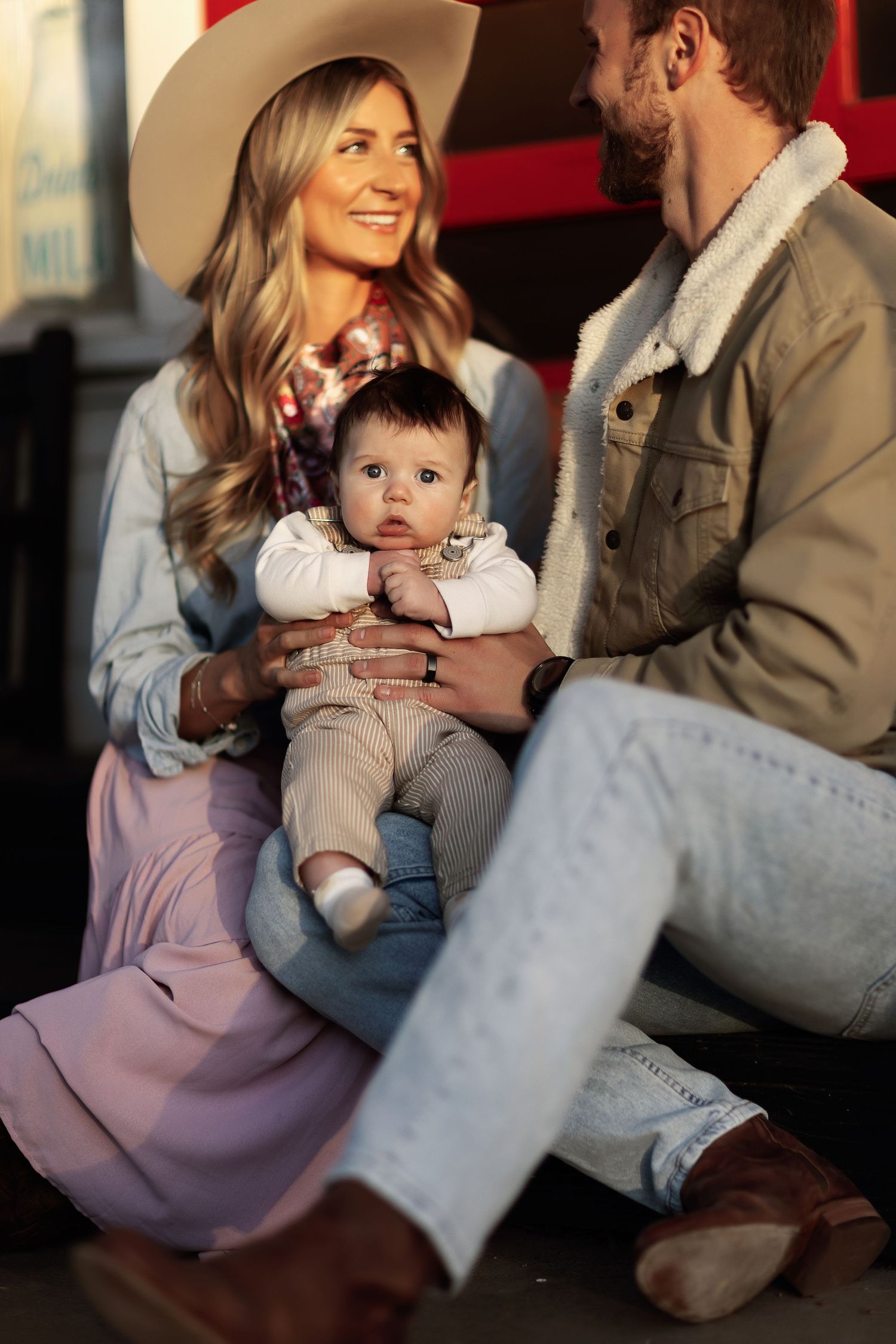 A family sits together on a floor sharing tender moments in a sequence of connected candid photographs.