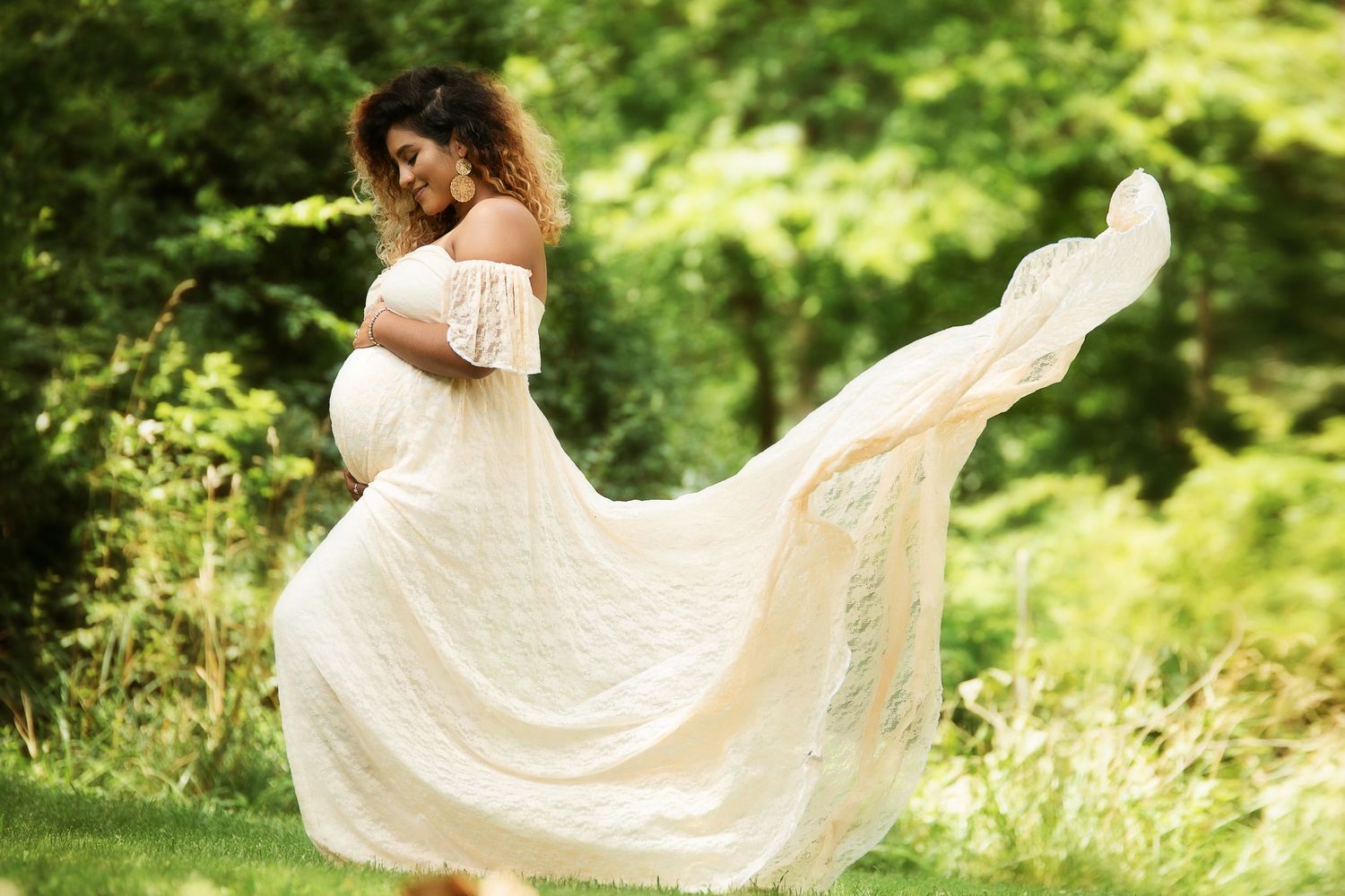 Flowing white dress twirls gracefully in a sunlit garden setting.