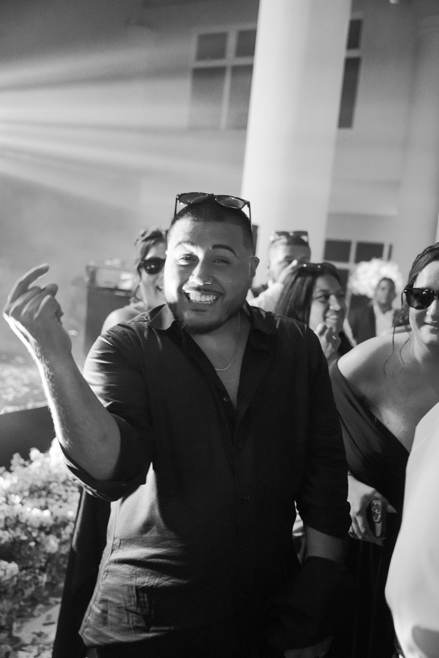 Black and white photo sequence showing joyful laughter and expressions at a social gathering.