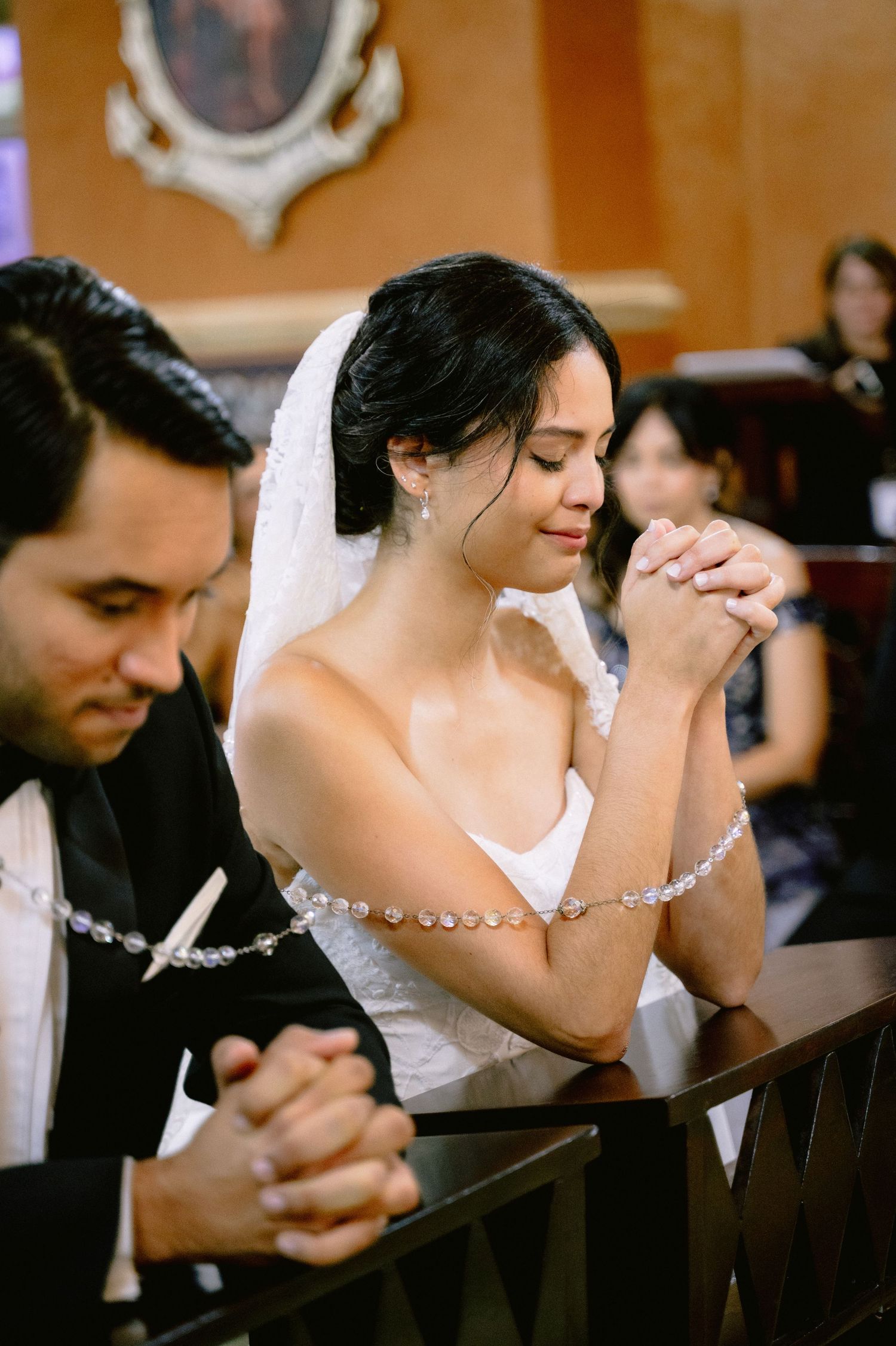 A series of emotional wedding photos showing a couple bowing their heads in prayer during a church ceremony.
