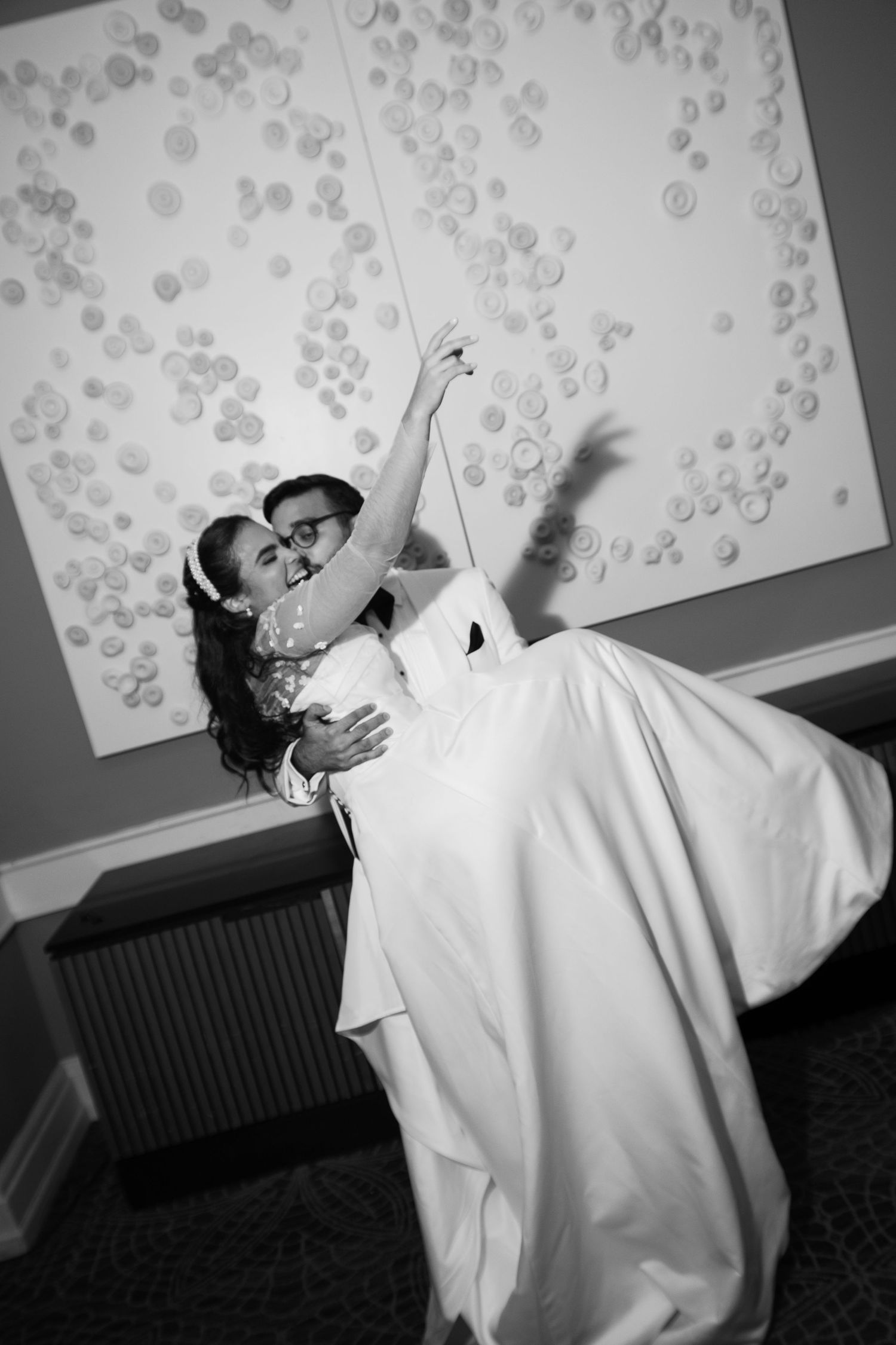 Black and white photo sequence of a couple performing a dramatic dance dip against a patterned wall.
