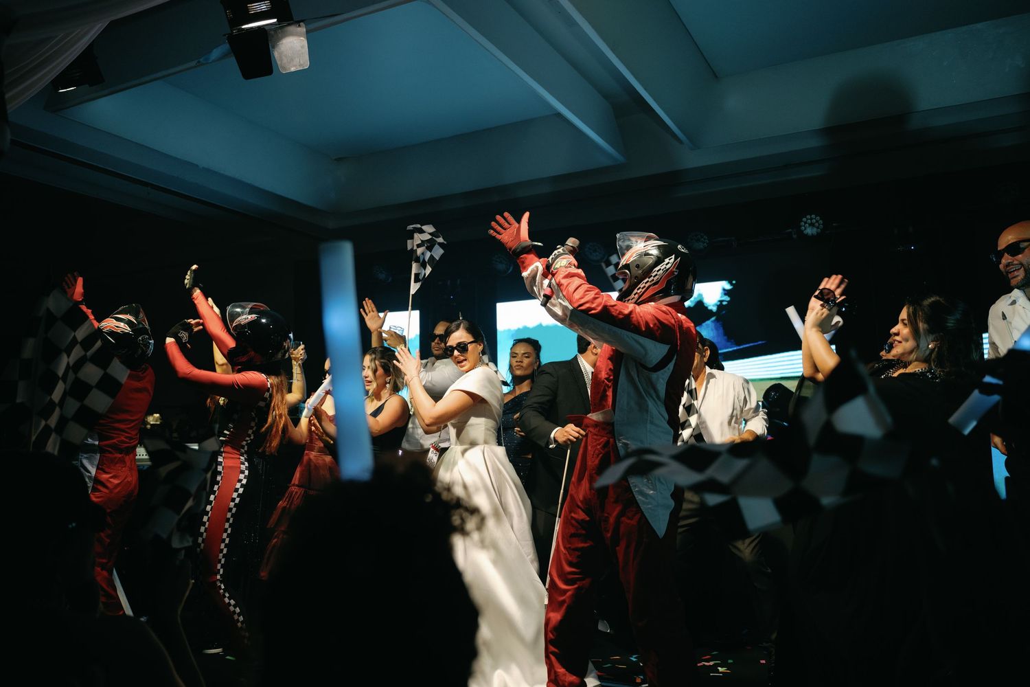 A sequence of dance moves captured in low light showing a person in white dress performing energetic spins and twirls.