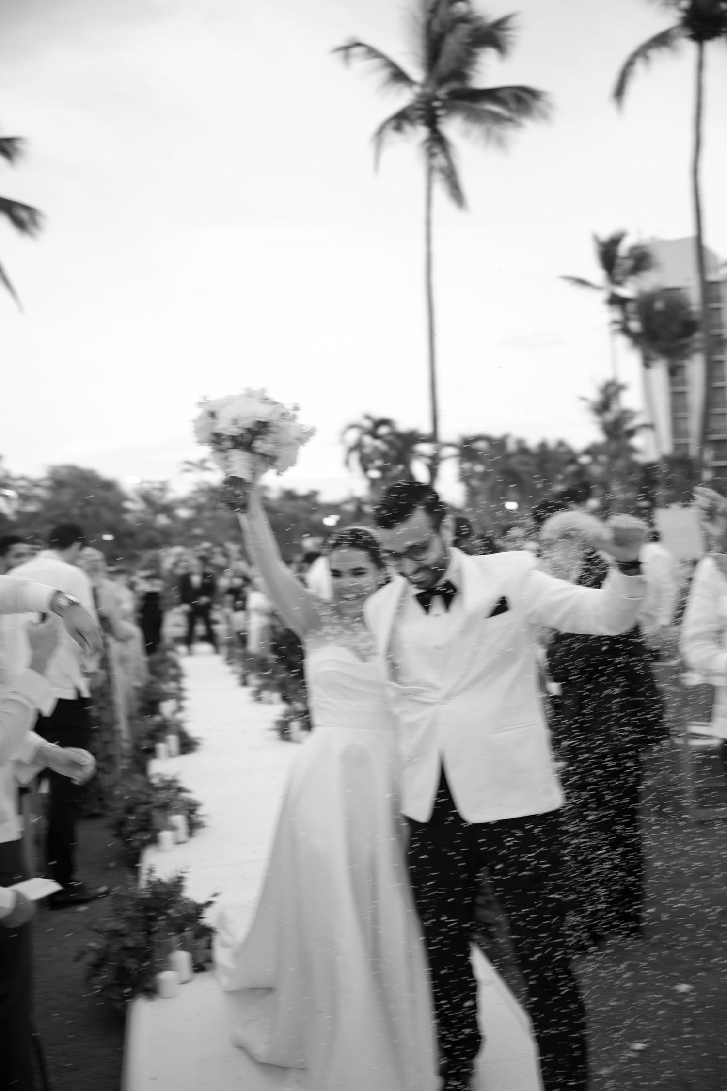 A black and white photo sequence shows a couple dancing at an outdoor wedding reception with palm trees in the background.