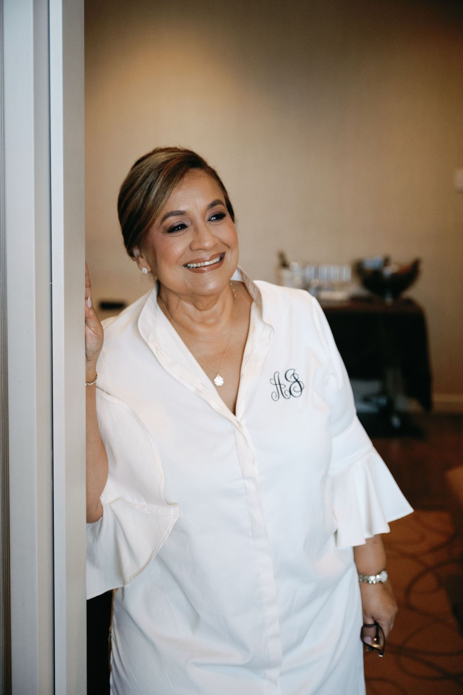 A series of candid shots showing someone in a white button-up shirt smiling and laughing during wedding preparations.