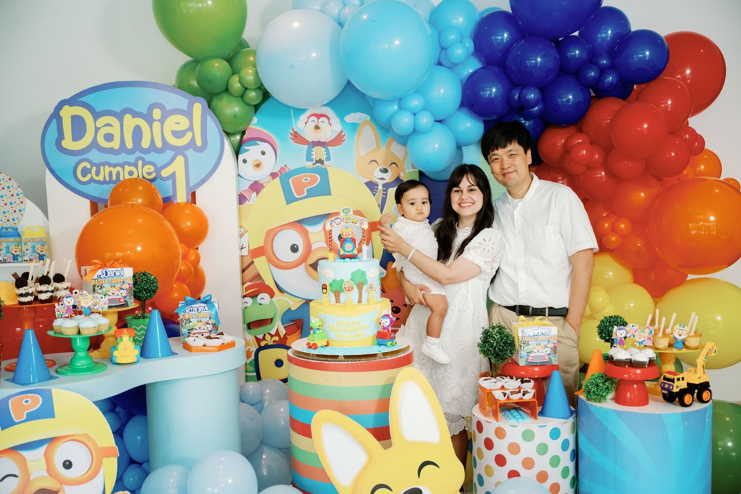 Colorful balloon decorations and party setups featuring Daniel Tiger theme with blue, green, and orange balloons and banners.