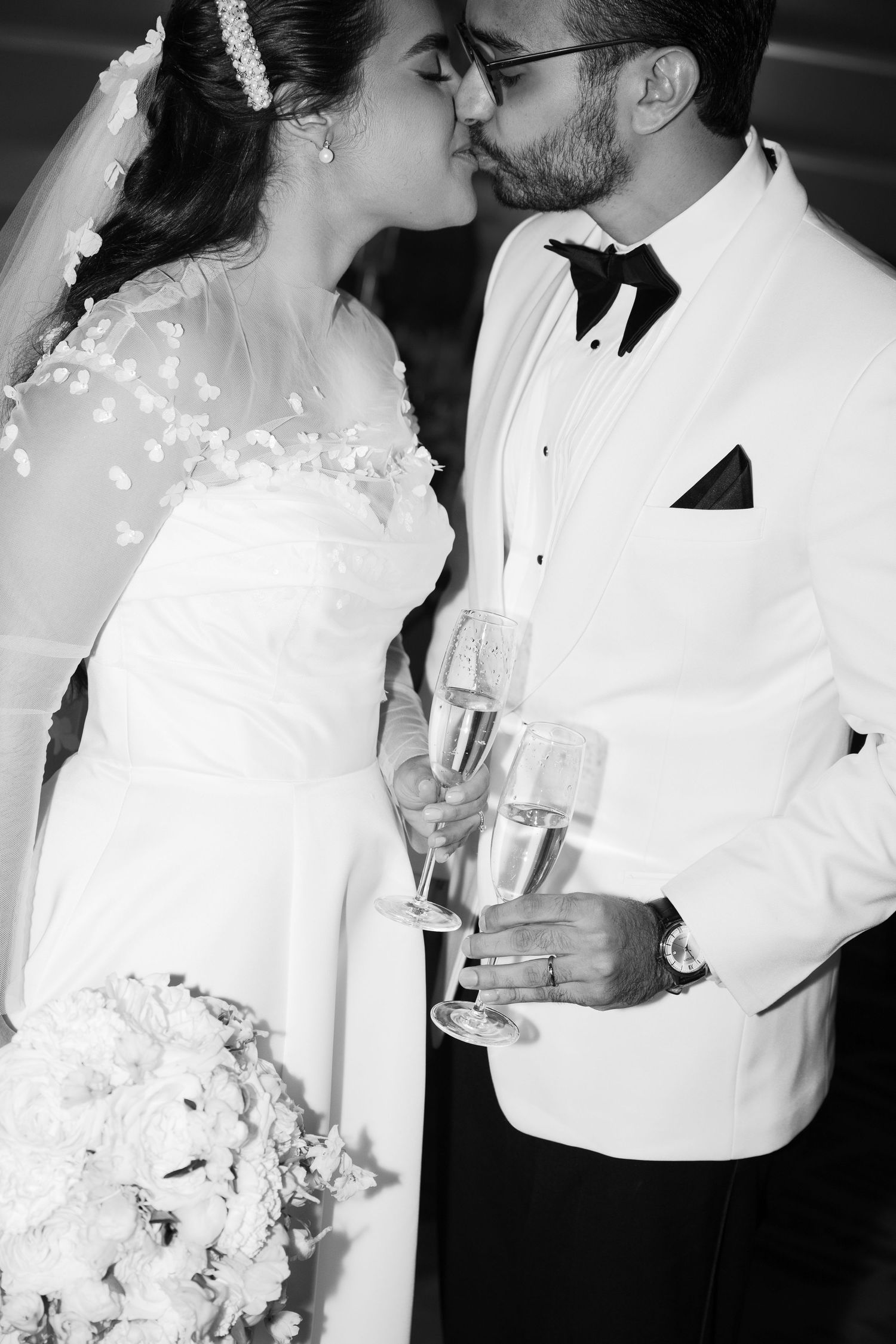 A series of romantic black and white wedding photos showing intimate moments between newlyweds.