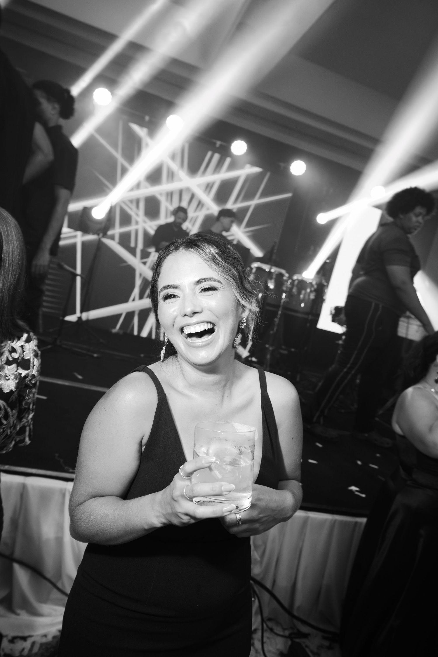 A series of black and white candid party photos showing joyful expressions and laughter at a festive celebration.