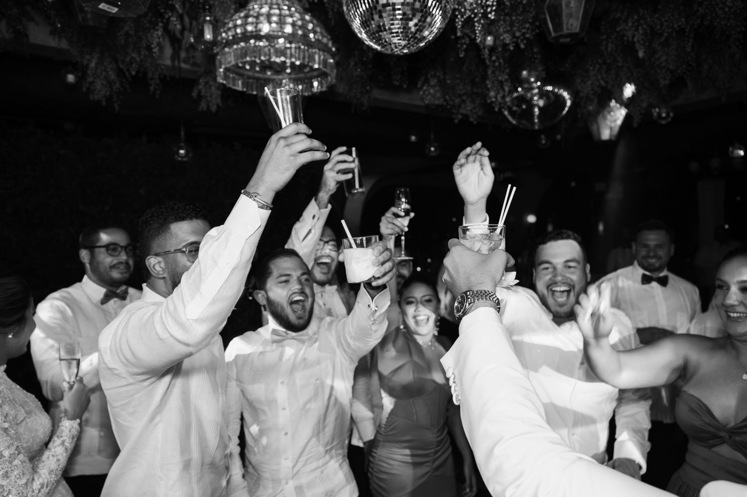 Collage of black and white photos showing people dancing and celebrating at a party or nightclub.