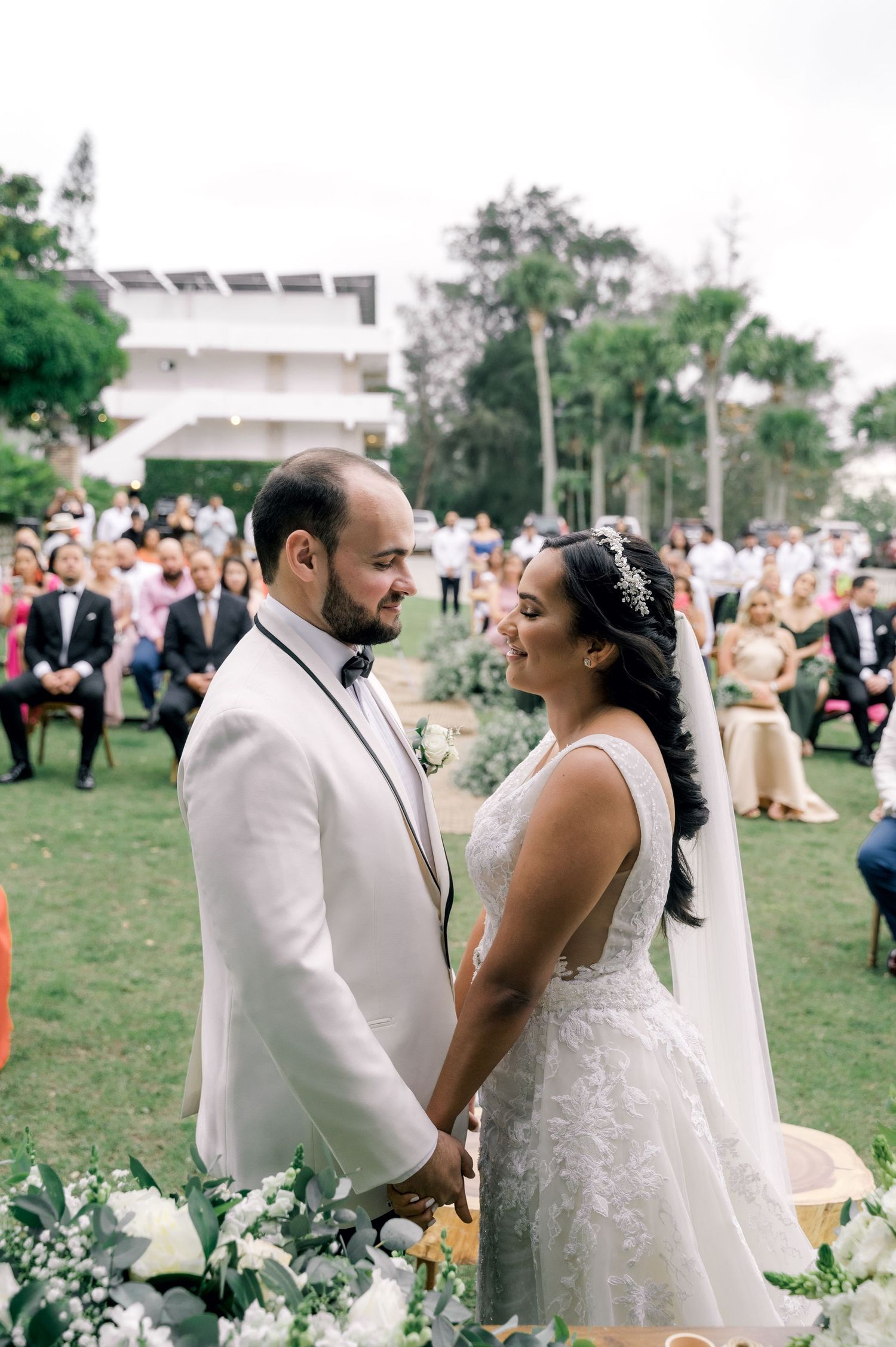 A joyful wedding couple shares intimate moments during their outdoor garden ceremony celebration.
